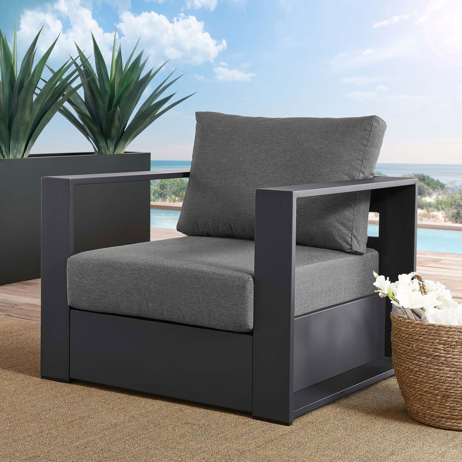 Tahoe aluminum outdoor armchair with gray cushions arranged on a sunny poolside deck || EEI-5675-GRY-CHA || front_angle_room