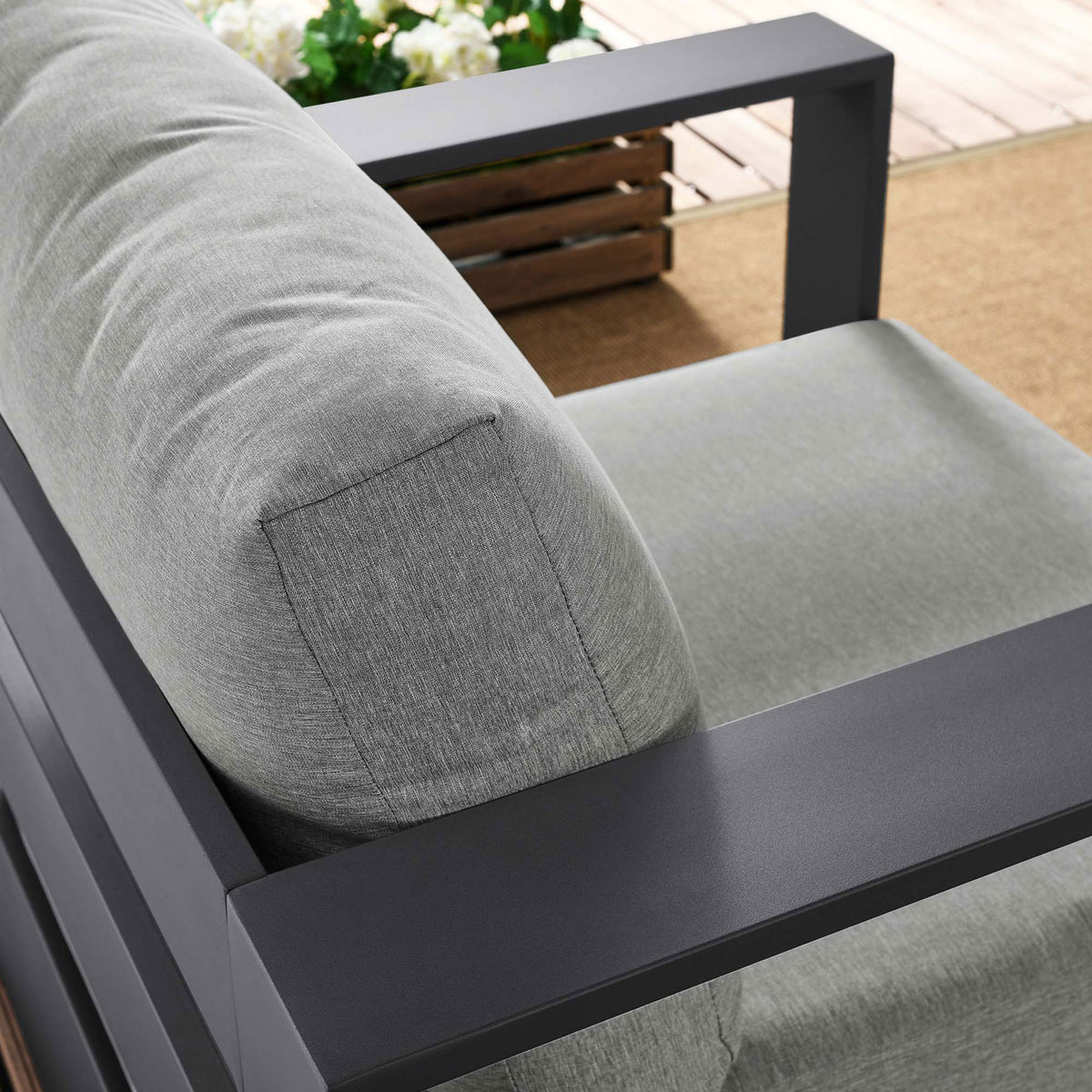 Tahoe armchair back cushion and armrest styled outdoors with textured light gray upholstery and dark frame || EEI-5675-GRY-GRY || detail_room