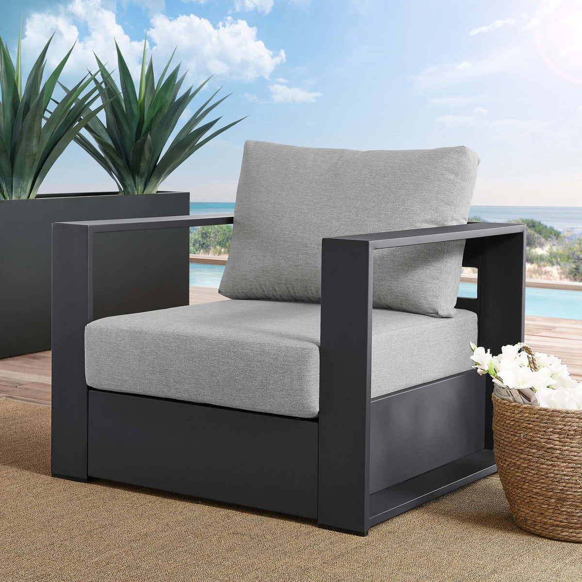 Tahoe aluminum outdoor armchair with light gray cushions arranged on a breezy poolside deck || EEI-5675-GRY-GRY || front_angle_room