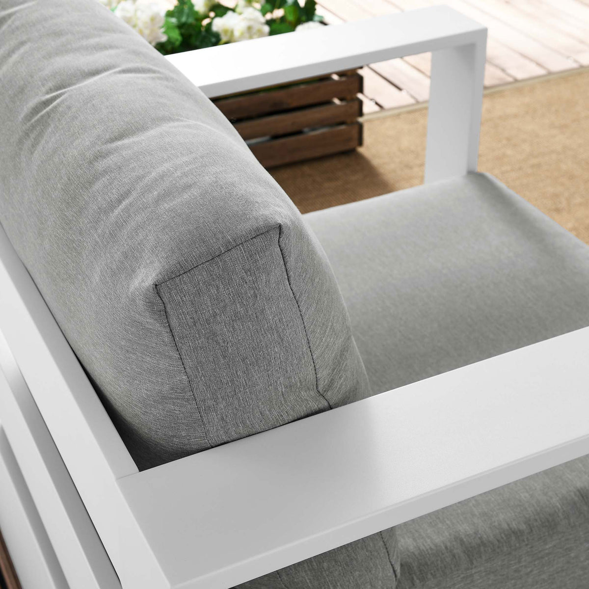 Tahoe armchair back cushion and white armrest arranged outdoors with textured light gray upholstery || EEI-5675-WHI-GRY || detail_room
