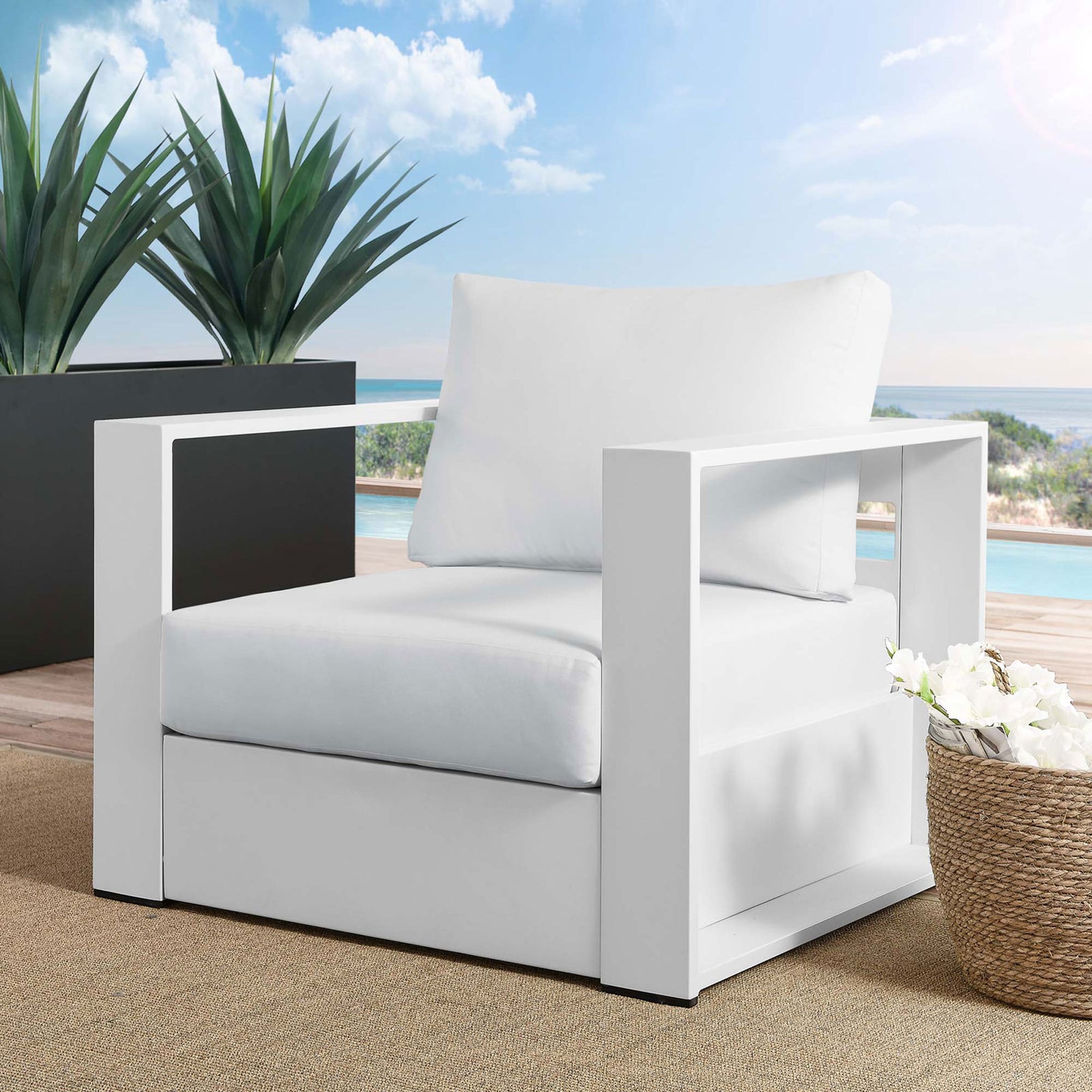 Tahoe white aluminum outdoor armchair with white cushions arranged on a bright poolside deck || EEI-5675-WHI-WHI || front_angle_room