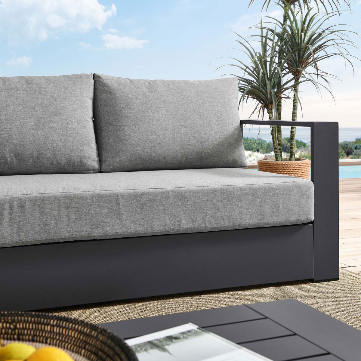 Lifestyle close-up of the Tahoe sofa highlighting the soft gray upholstery and charcoal frame. || EEI-5676-GRY-GRY || detail_room