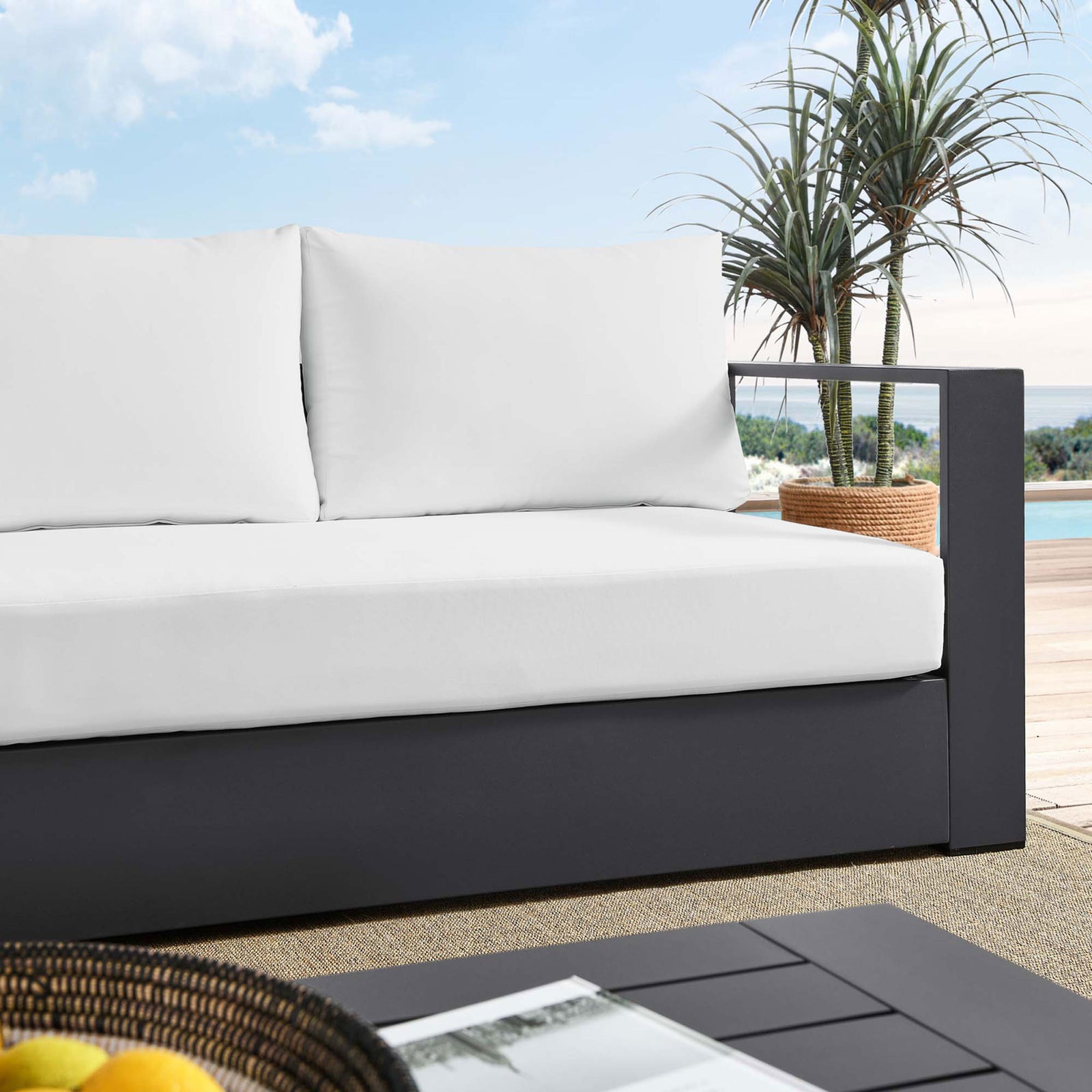 Close lifestyle view of the Tahoe sofa showing bright white cushions against the charcoal frame. || EEI-5676-GRY-WHI || detail_room