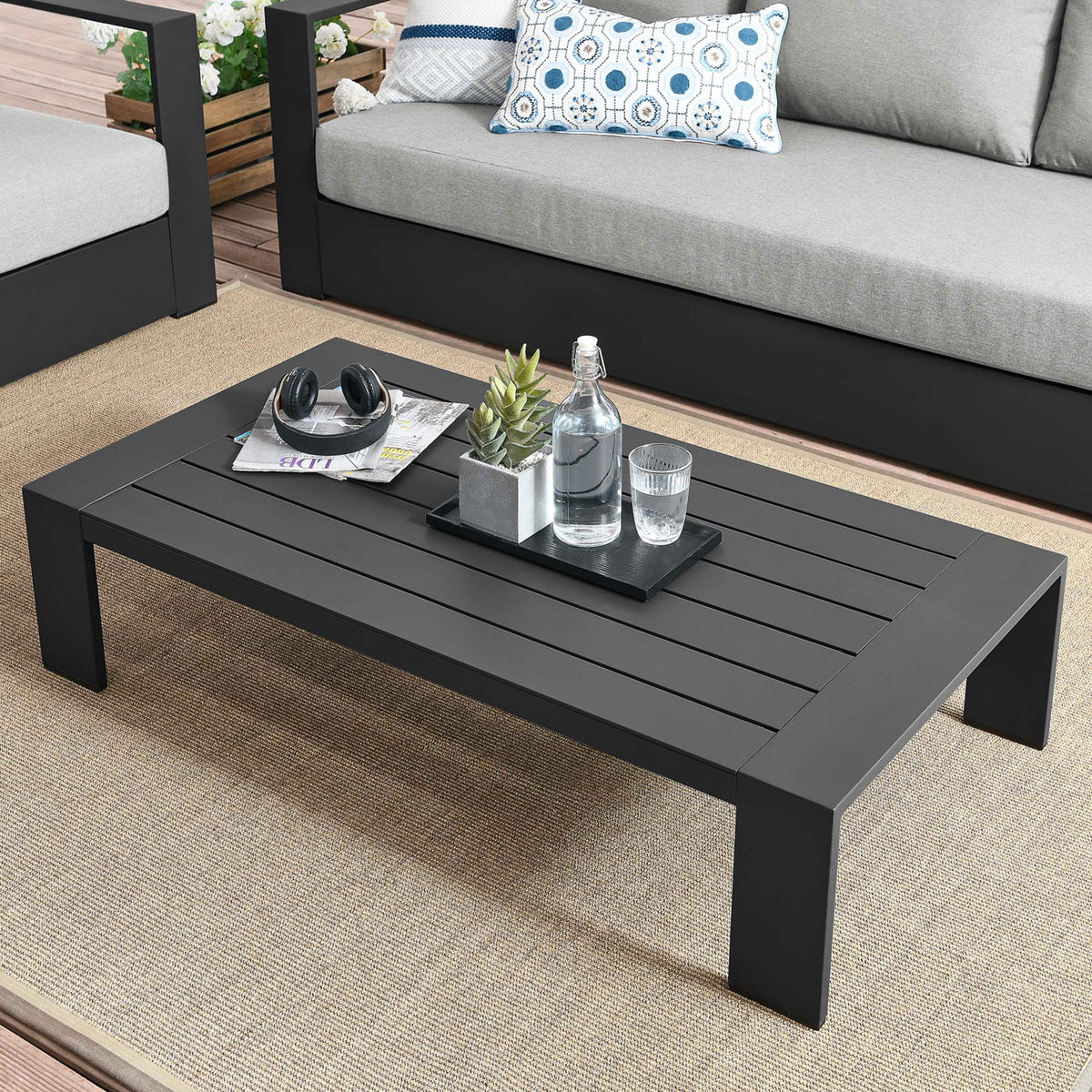 Gray aluminum coffee table arranged with outdoor seating to create a modern patio lounge || EEI-5677-GRY || front_angle_room