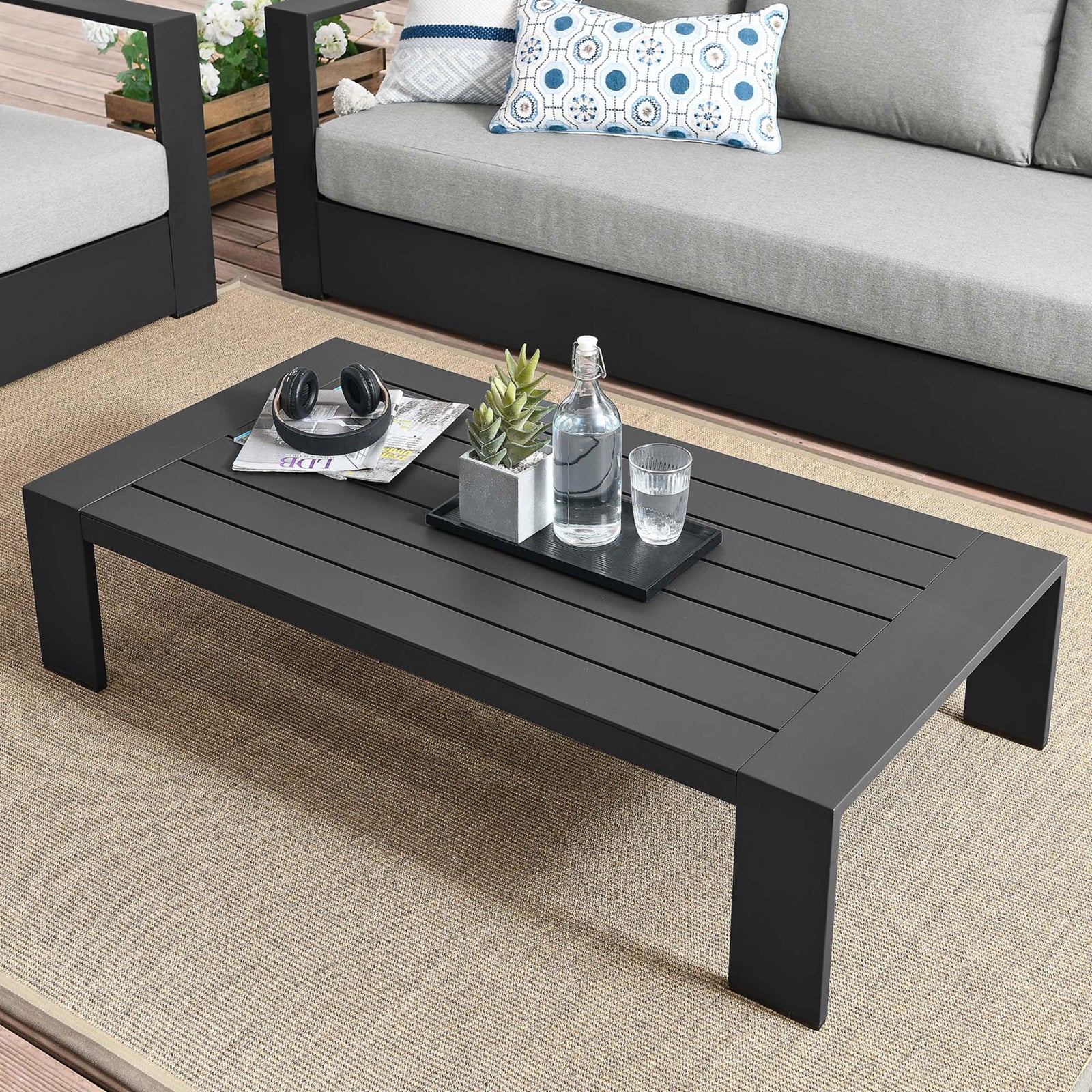 Gray aluminum coffee table arranged with outdoor seating to create a modern patio lounge || EEI-5677-GRY || front_angle_room