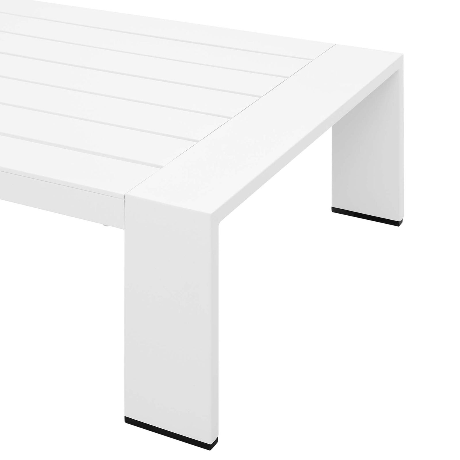 Corner detail of the white aluminum coffee table with sleek edges and dark leg caps || EEI-5677-WHI || leg_studio