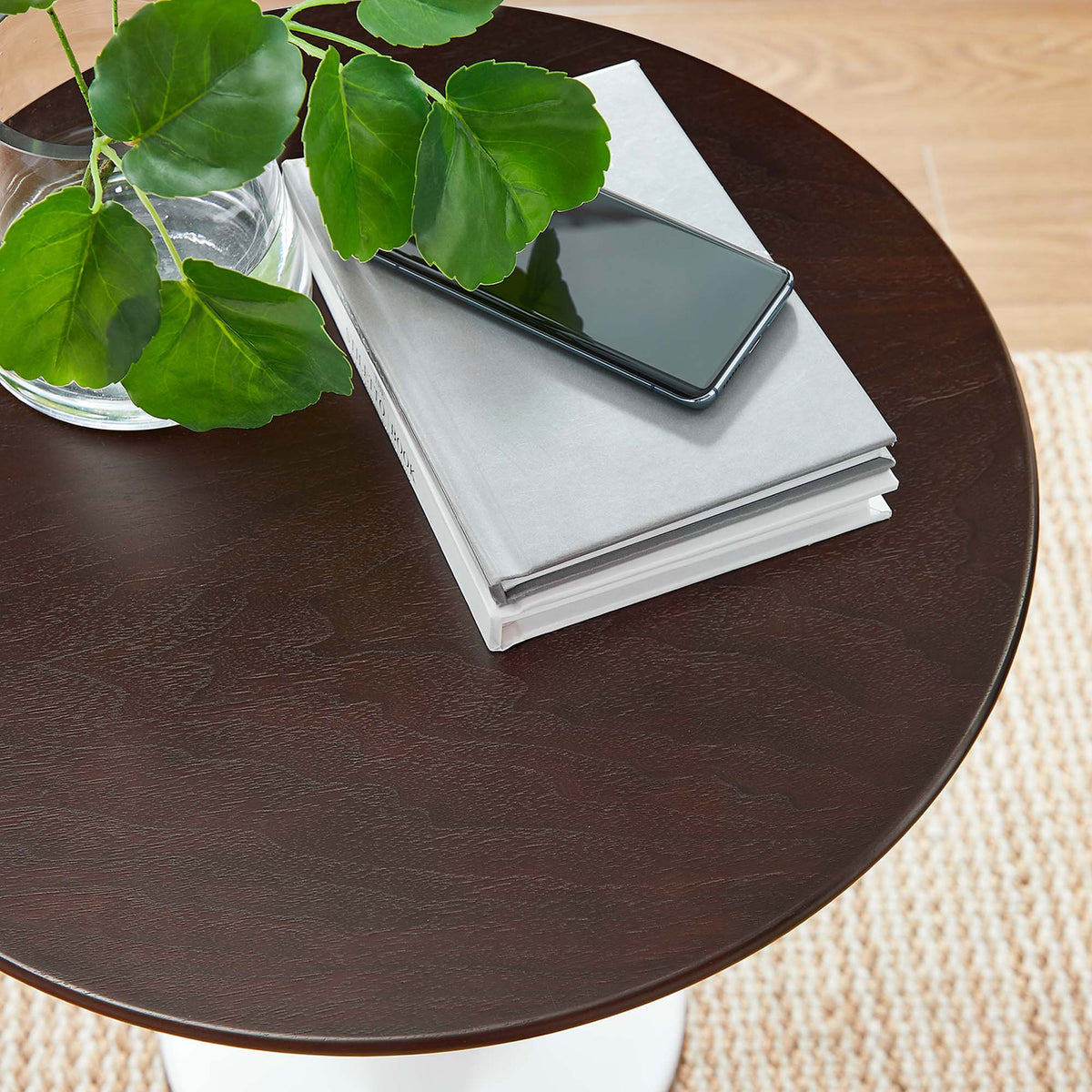 Tabletop styled with books, smartphone, and greenery, showing rich wood grain in a bright room || EEI-5679-WHI-CHE || detail_room