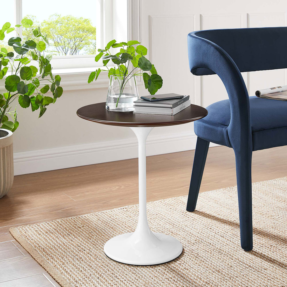 Round side table with dark wood top and white pedestal base beside a modern blue accent chair || EEI-5679-WHI-CHE || front_angle_room