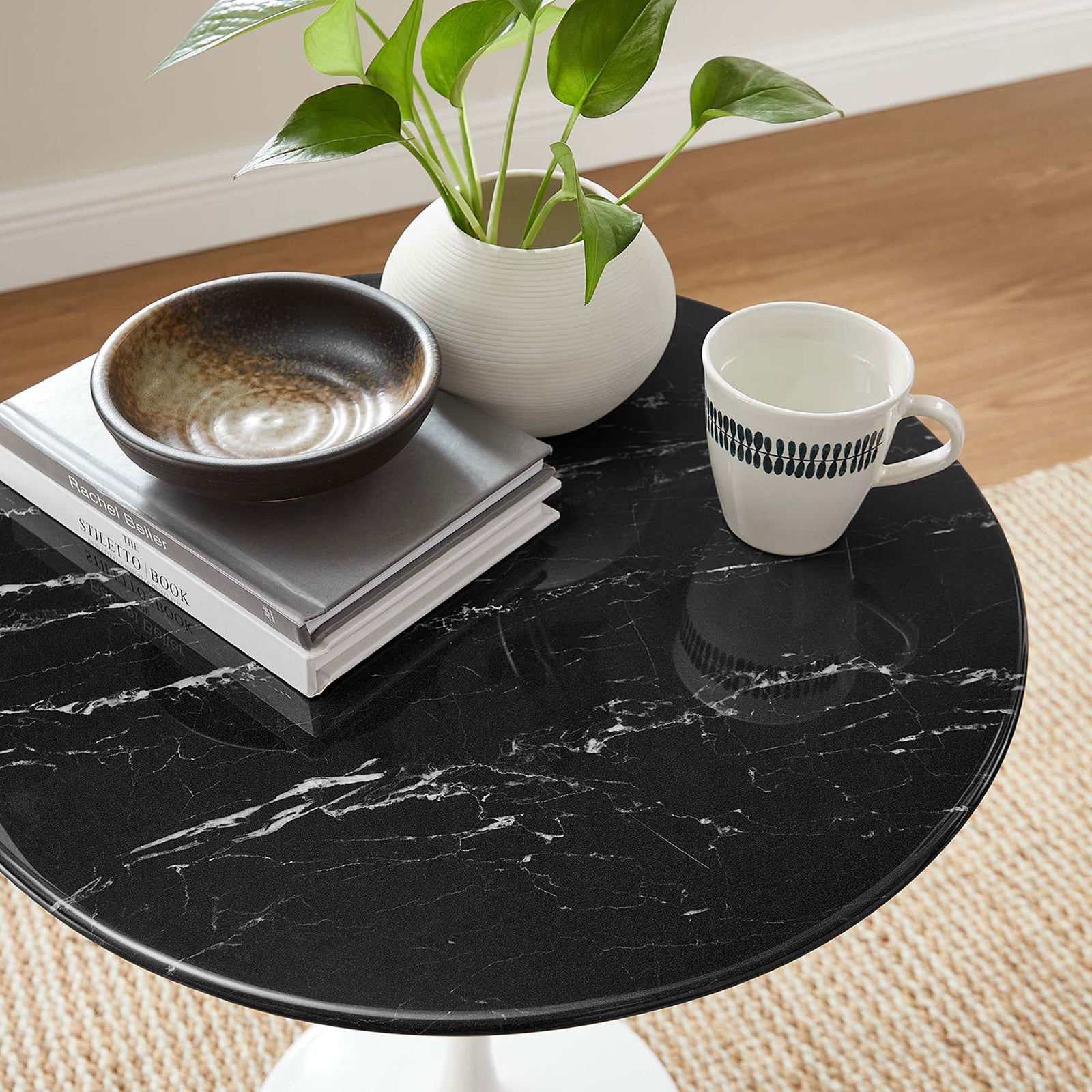 Styled Lippa side table showing black faux marble top with books, ceramics, and a mug. || EEI-5680-WHI-BLK || detail_room