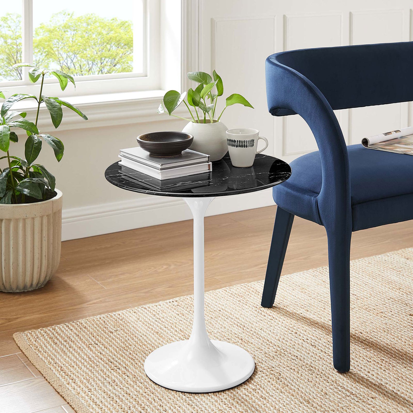 Modern Lippa side table with black faux marble top beside a blue accent chair in a bright room. || EEI-5680-WHI-BLK || front_angle_room