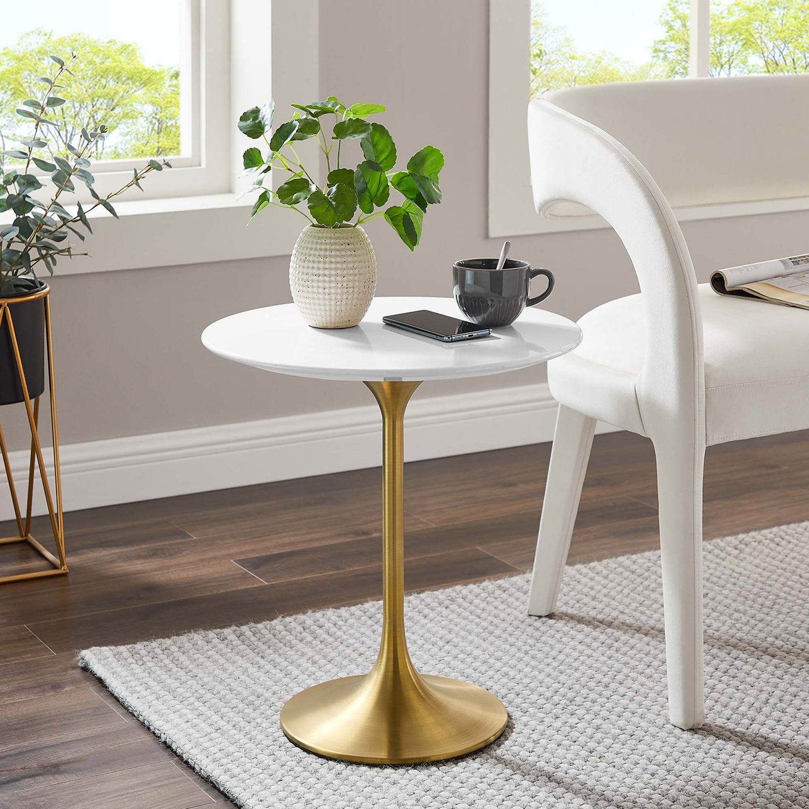 Lippa white and gold side table adding mid-century charm beside an accent chair in a cozy room || EEI-5683-GLD-WHI || front_angle_room