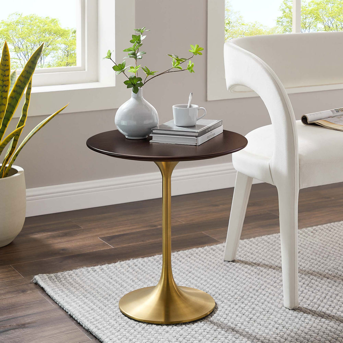 Round side table with walnut grain top and gold pedestal base styled beside a modern accent chair || EEI-5684-GLD-CHE || front_angle_room