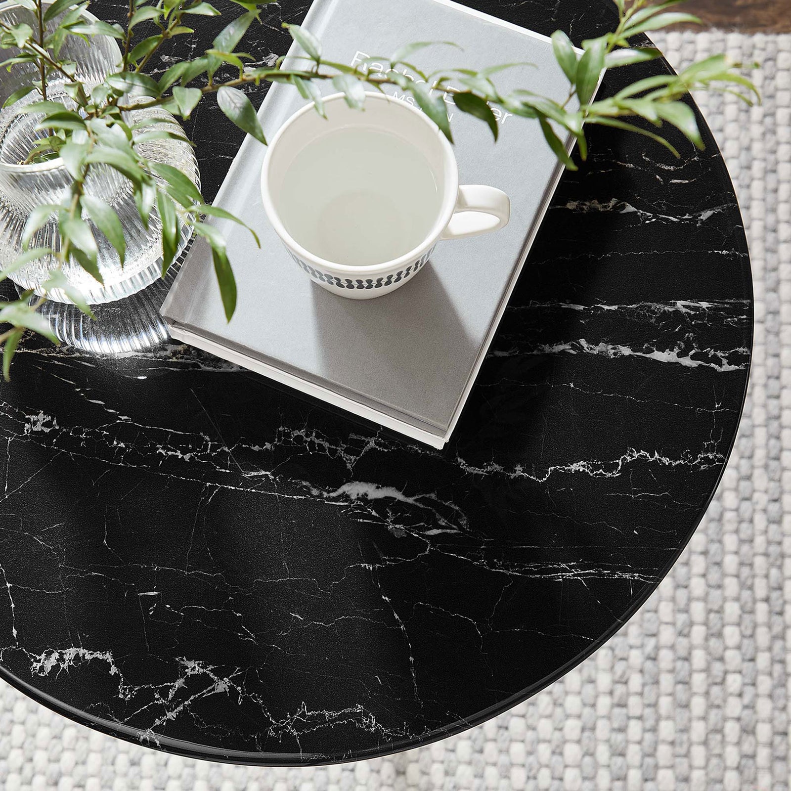 Styled black faux marble side table top with greenery, mug, and books in a cozy room setting || EEI-5685-GLD-BLK || detail_room