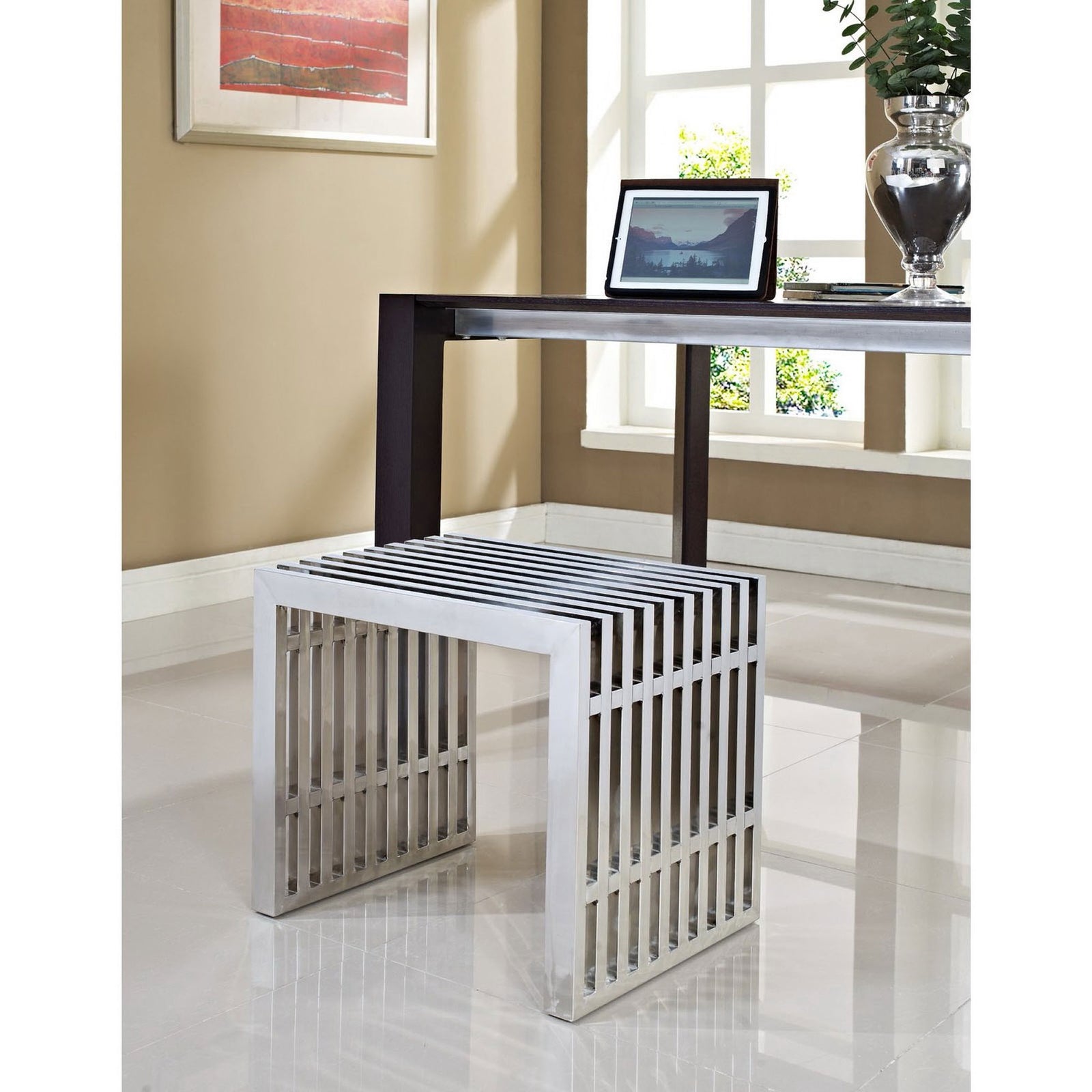 Stainless steel bench adds modern shine beneath a desk in a bright, contemporary workspace || EEI-569-SLV || front_angle_room