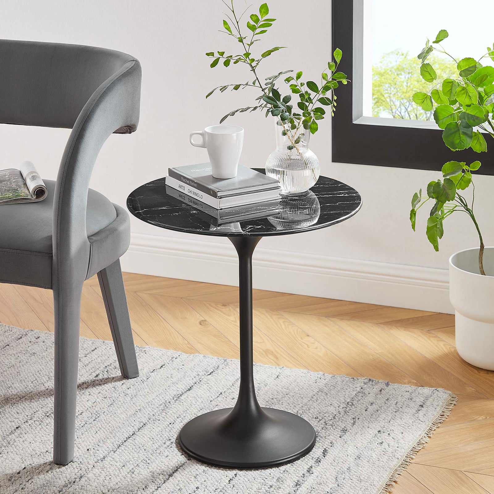 Lippa black faux marble side table adding modern contrast beside a gray chair in a sunny room || EEI-5690-BLK-BLK || front_angle_room