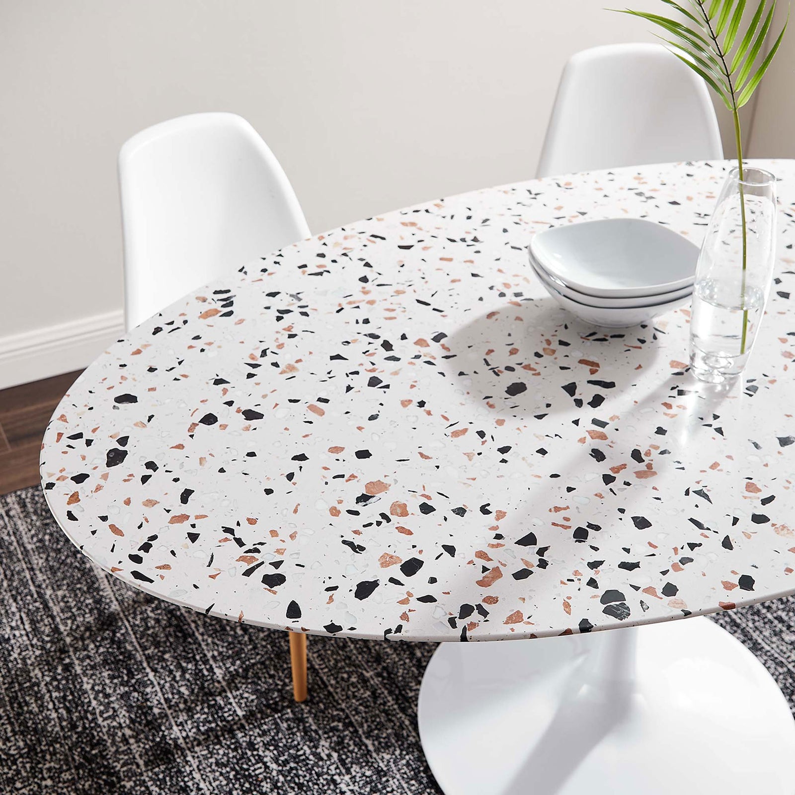 Terrazzo dining tabletop styled with minimalist dinnerware on a textured rug for a cozy modern dining space || EEI-5734-WHI-WHI || detail_room