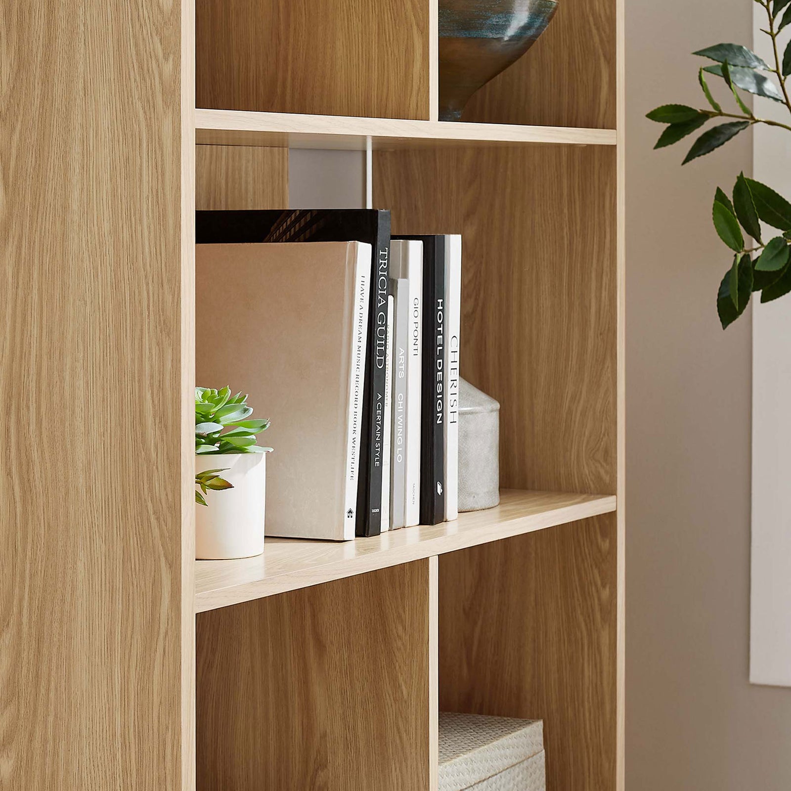 Shelves styled with books and greenery highlight the versatile open storage || EEI-5743-OAK || detail_room