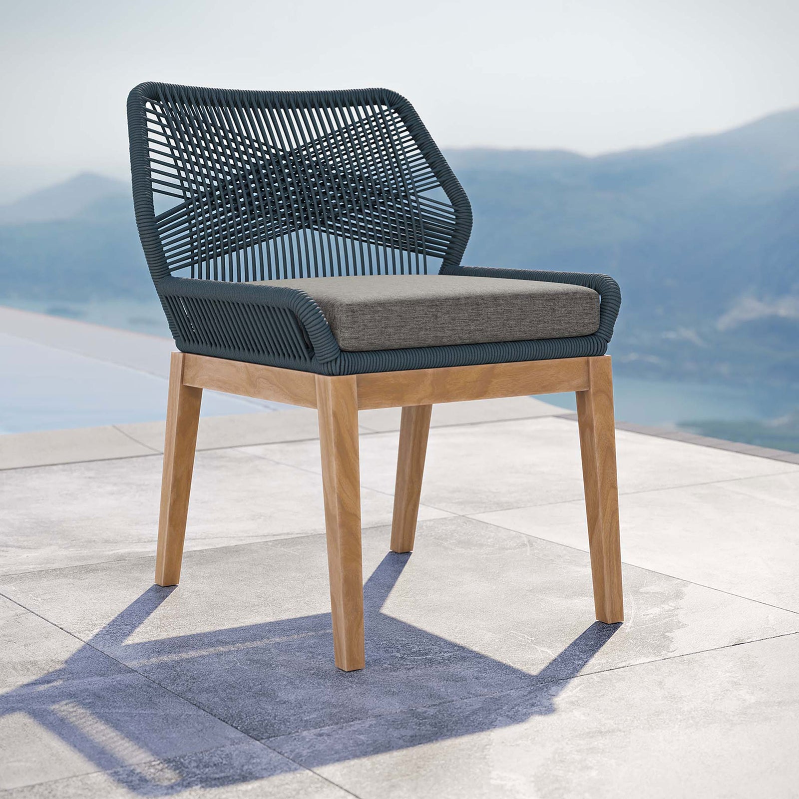 Blue graphite rope dining chair with gray cushion styled on a poolside terrace for relaxed outdoor gatherings || EEI-5747-BLU-GPH || front_angle_room