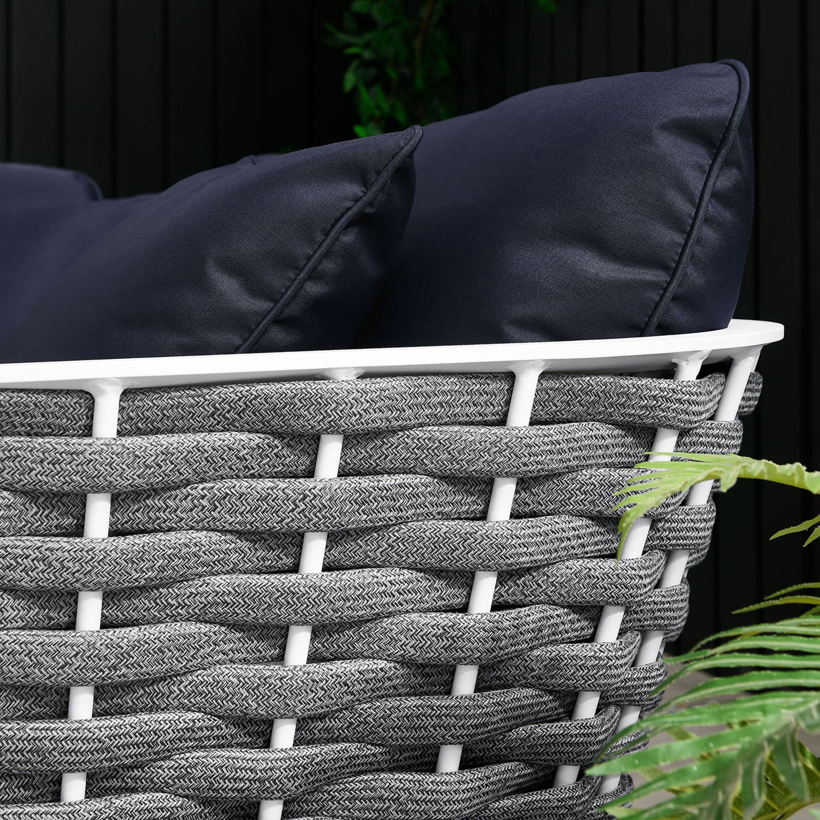 Outdoor setting shows navy cushions and braided rope trim paired with a crisp white frame and greenery || EEI-5752-WHI-NAV || detail_room