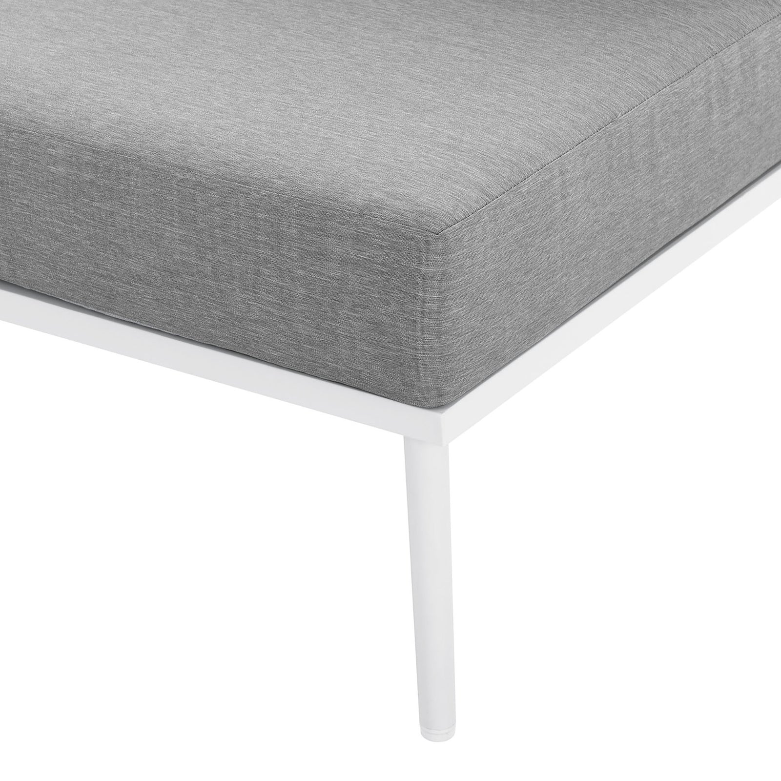 Slender white metal leg supports a thick gray cushion, underscoring the sectional's modern, airy design. || EEI-5753-WHI-GRY || leg_studio