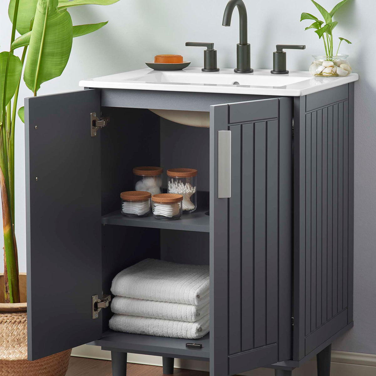 Ample cabinet storage keeps essentials tidy while the compact 24-inch vanity fits small baths || EEI-5800-GRY-WHI || front_angle_open_room