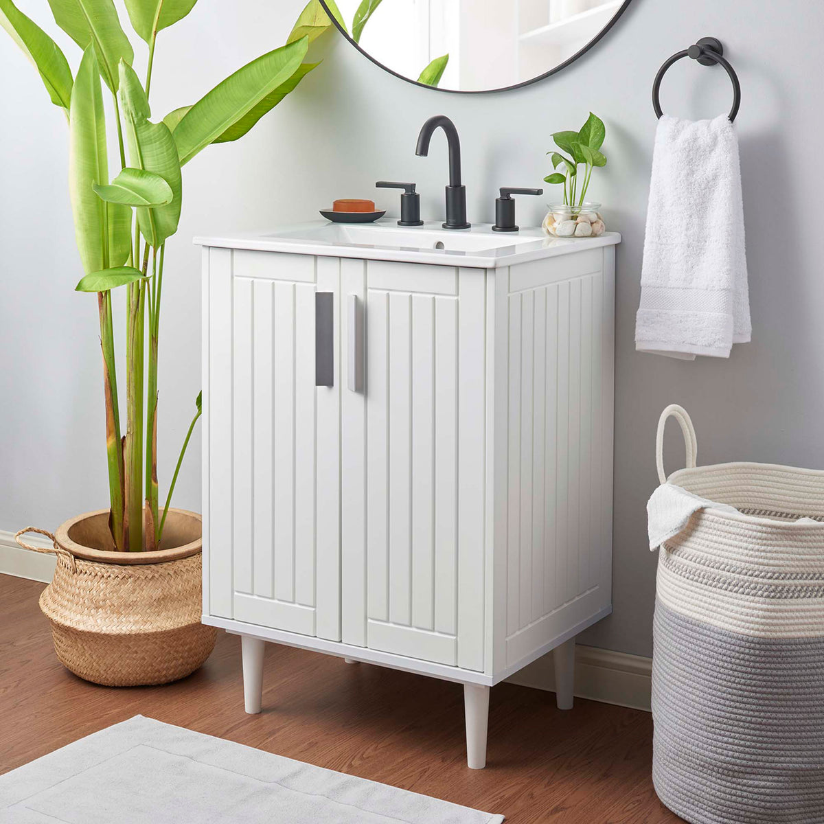 Crisp white vanity with paneled doors and an integrated sink elevates compact bath spaces || EEI-5800-WHI-WHI || front_angle_room