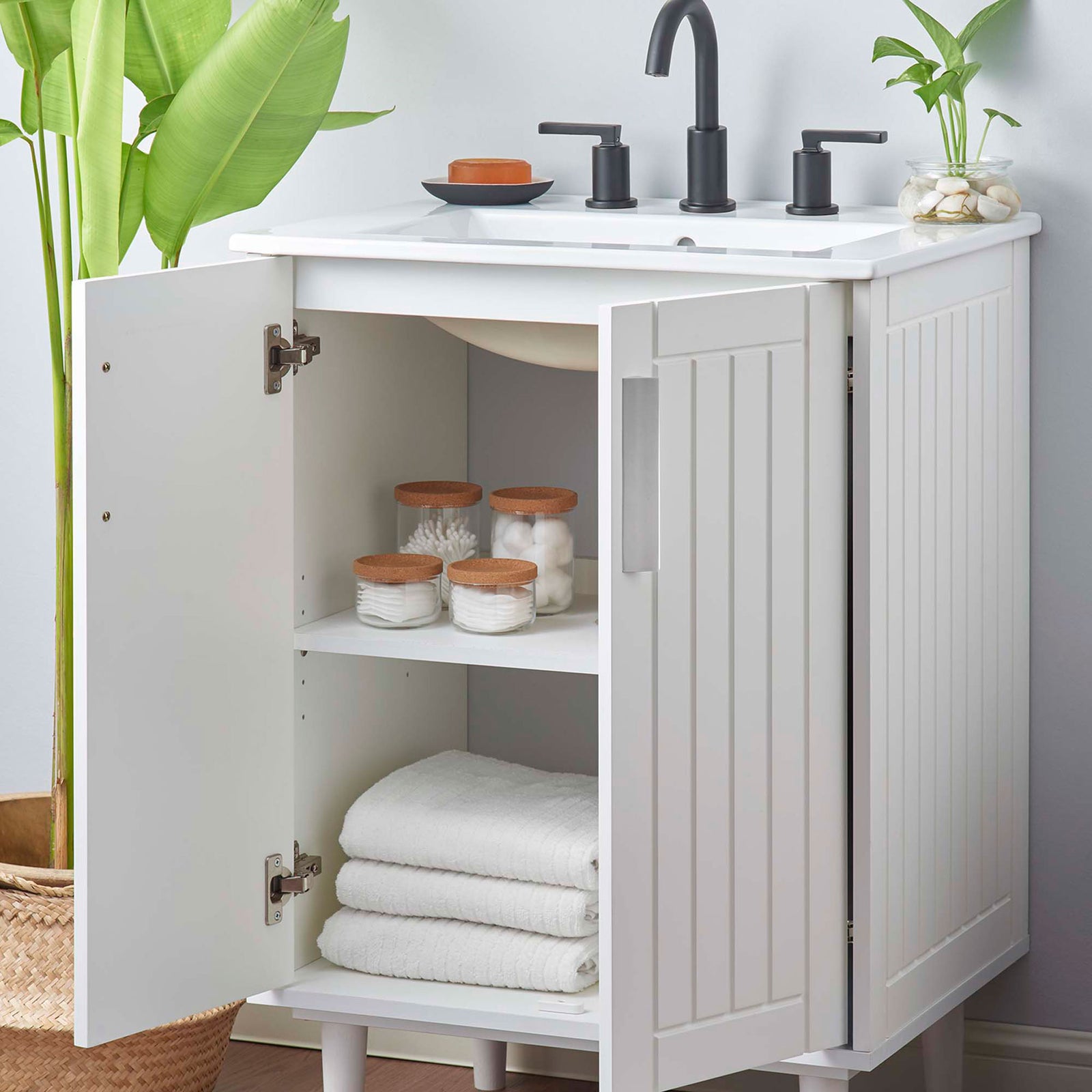 Open cabinet shows two-tier storage with plumbing cutout to keep bathroom essentials organized || EEI-5800-WHI-WHI || front_angle_open_room