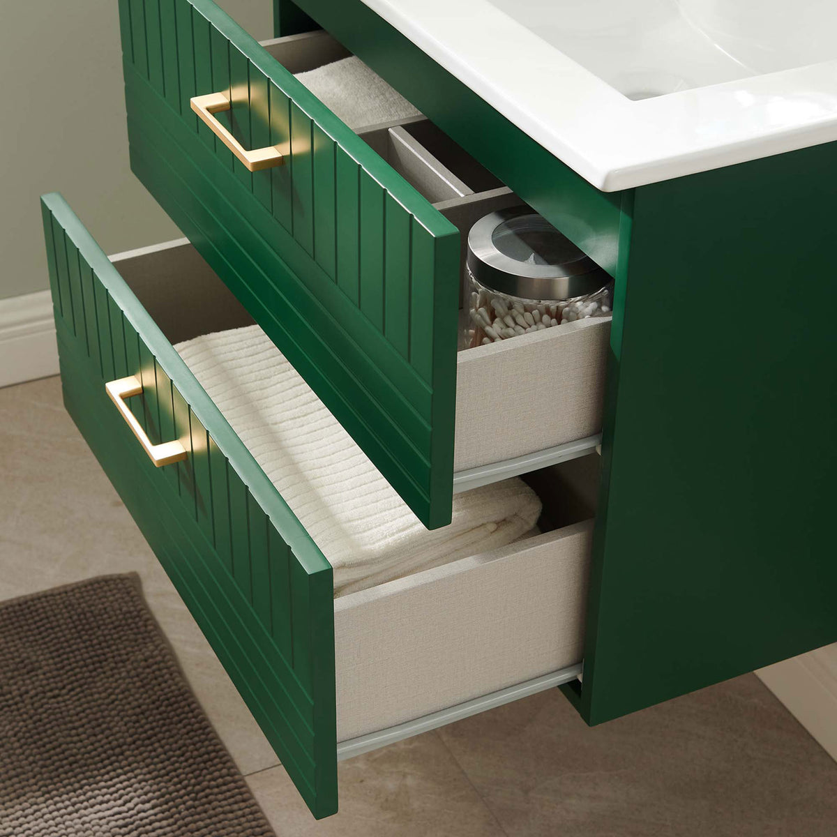 Open drawers neatly store towels and toiletries inside the textured green vanity. || EEI-5818-GRN-WHI || storage_open_room