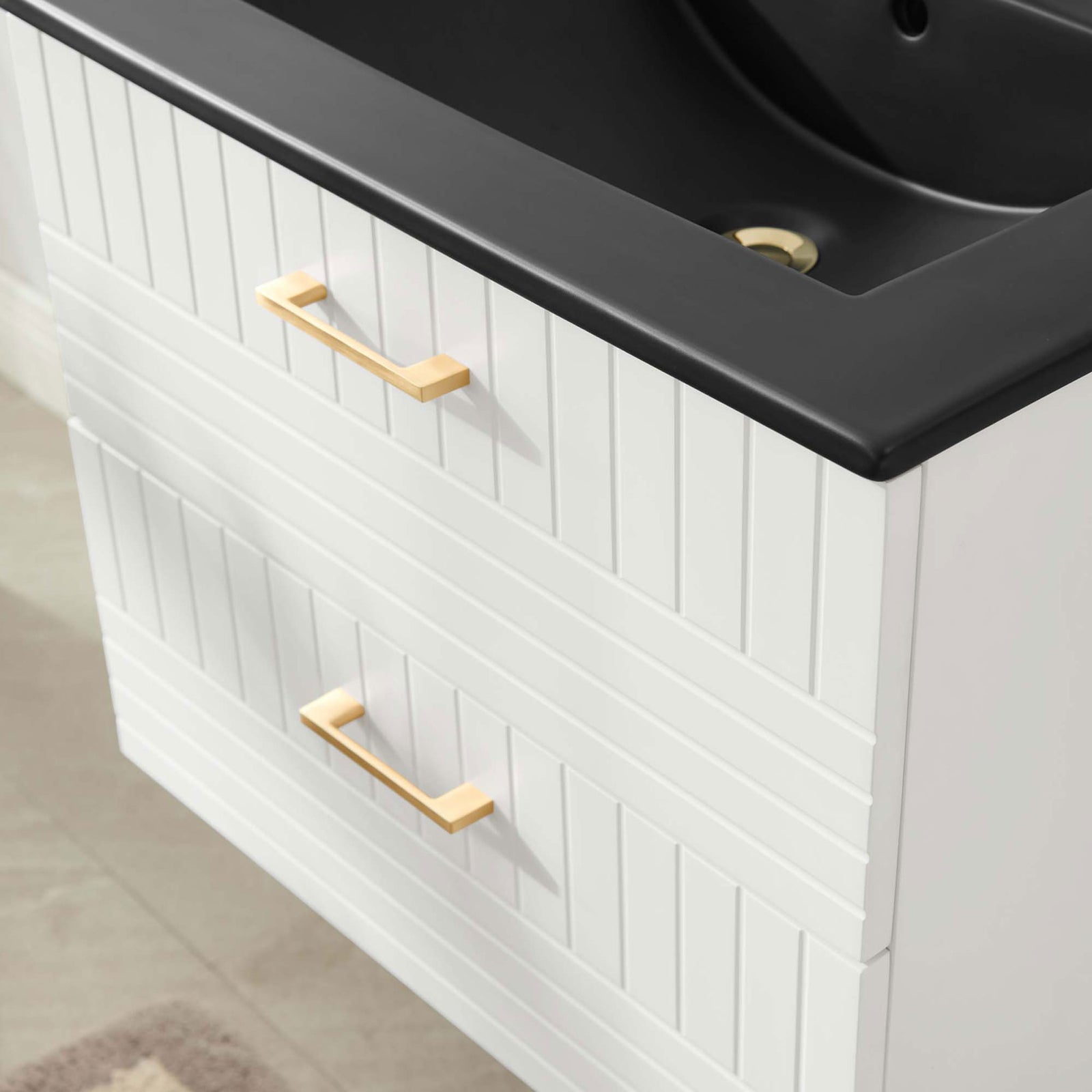 Textured drawer fronts and gold pulls add inviting warmth to a clean, contemporary bath || EEI-5820-WHI-BLK || detail_room