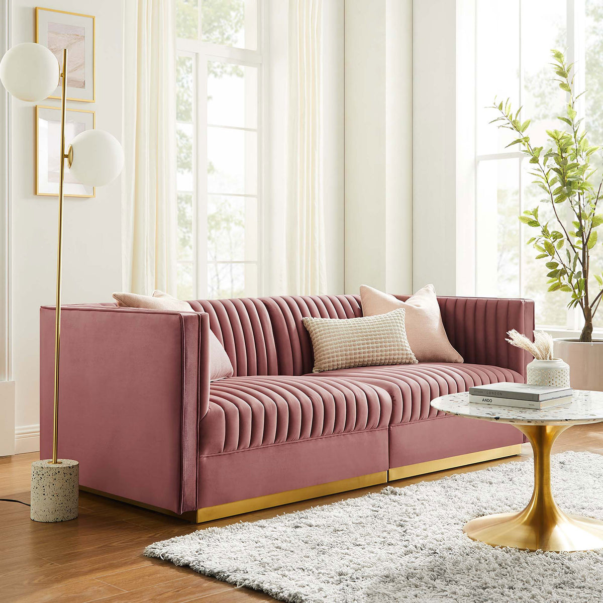 Dusty rose velvet channel tufted loveseat styled with pillows in a bright living room with gold accents || EEI-5824-DUS || front_room