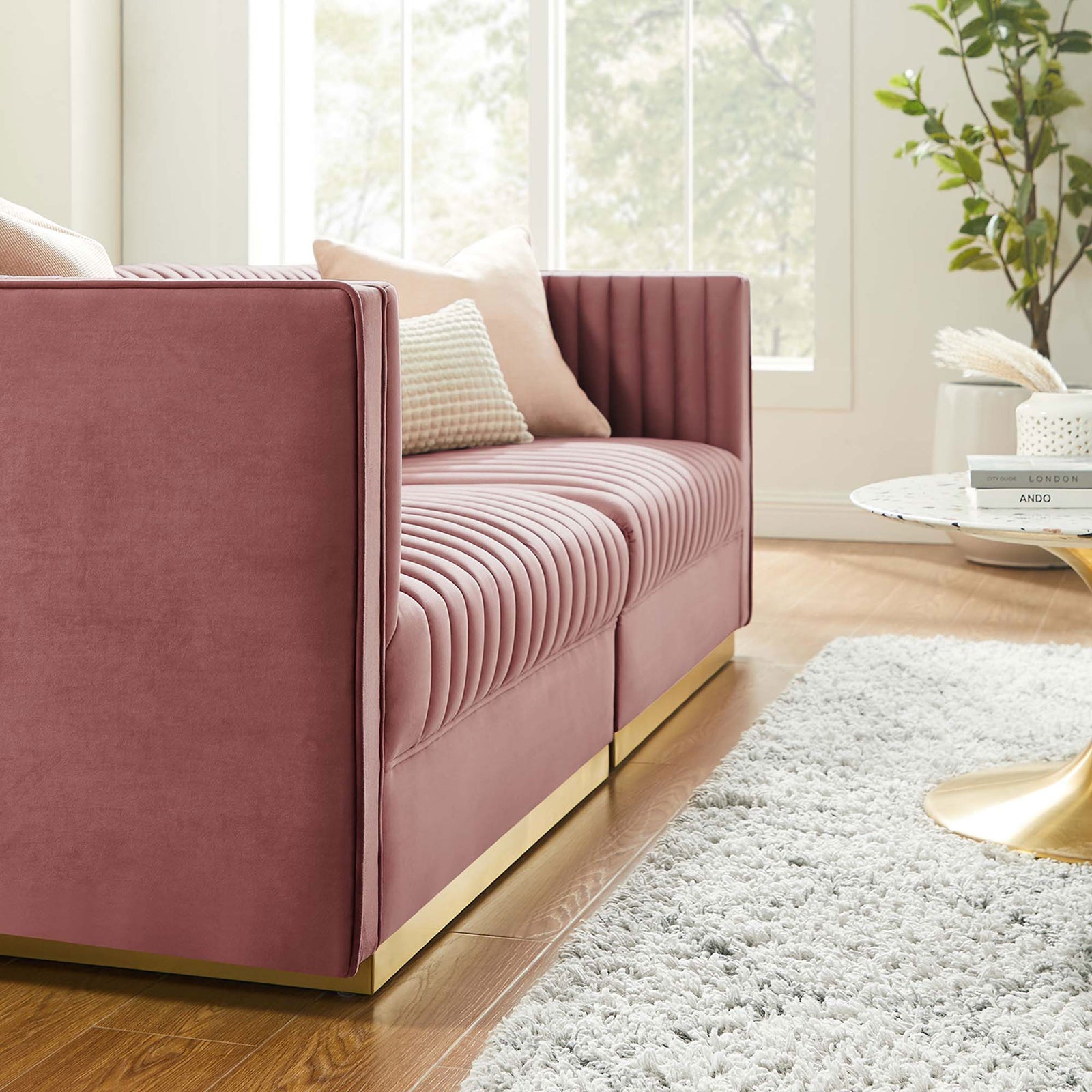 Dusty rose channel tufted velvet loveseat paired with a round gold base coffee table on a plush rug || EEI-5824-DUS || front_angle_room