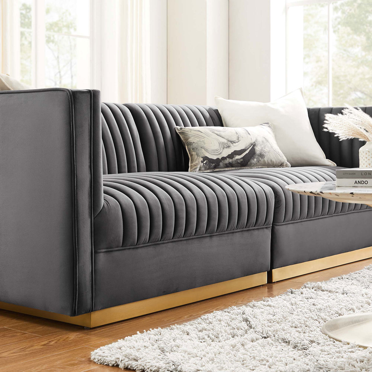 Gray channel-tufted velvet loveseat with gold base styled with plush pillows in a bright contemporary living space || EEI-5824-GRY || detail_room