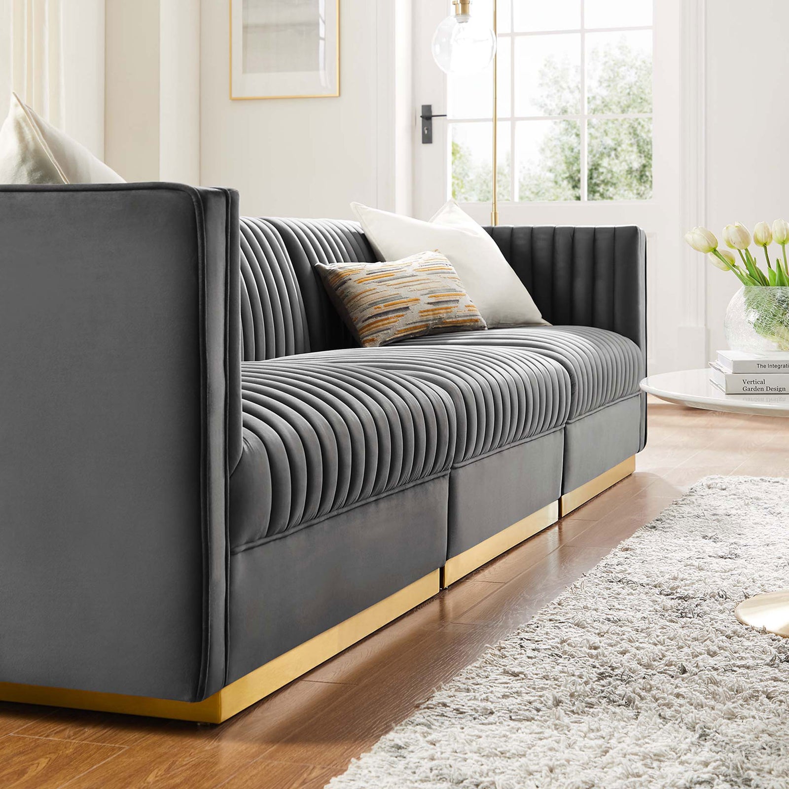 Gray velvet channel tufted modular sofa in a cozy living room with pillows and fresh tulips || EEI-5825-GRY || front_angle_room