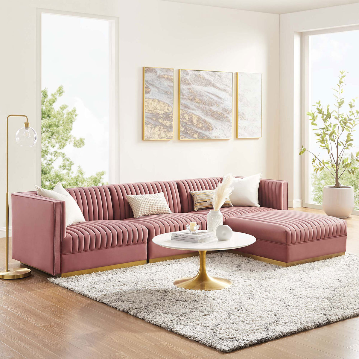 Bright living room featuring dusty rose modular sectional with chaise, round coffee table, and plush rug. || EEI-5826-DUS || front_angle_room