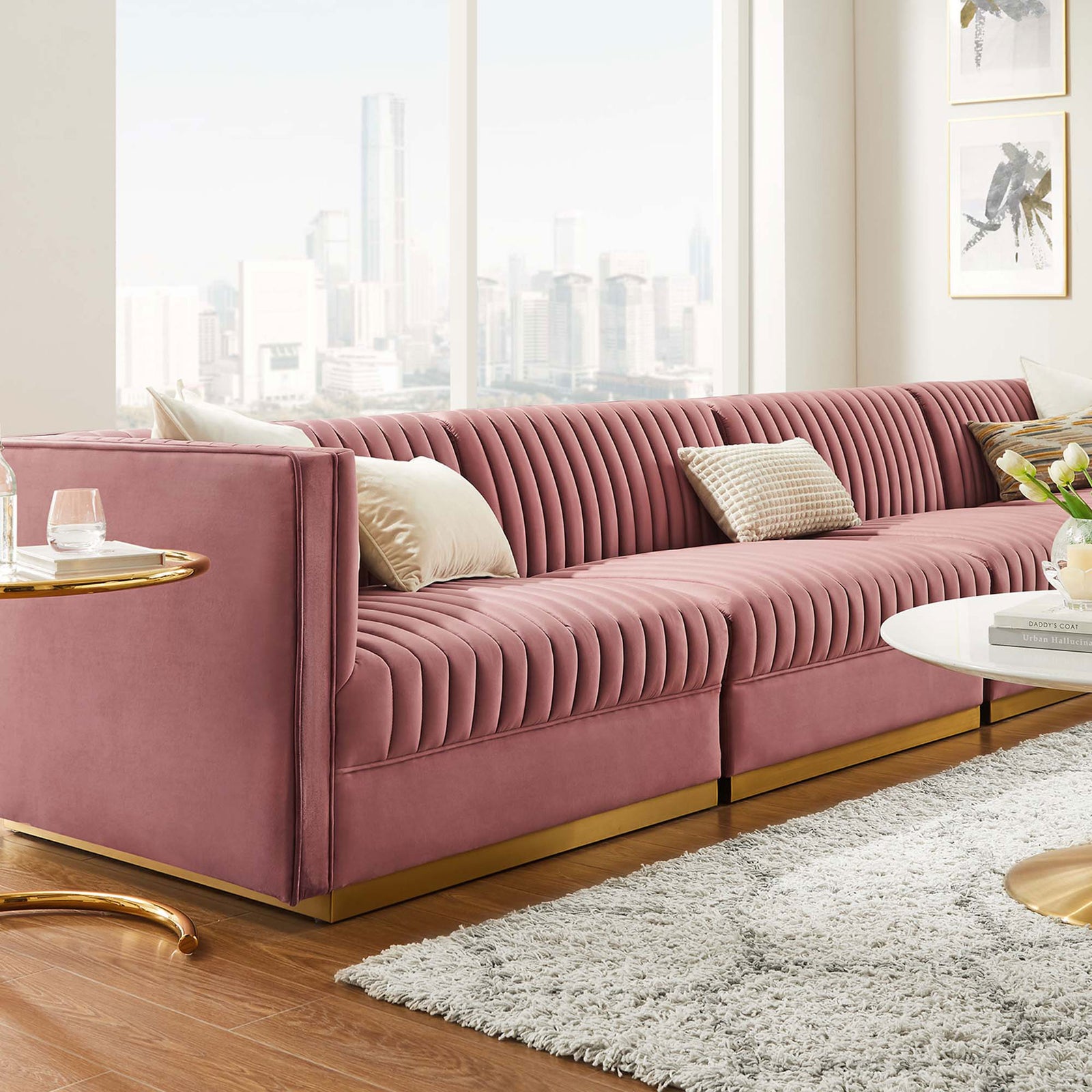 Dusty rose velvet modular sectional styled with pillows in a bright modern living room. || EEI-5827-DUS || front_angle_room