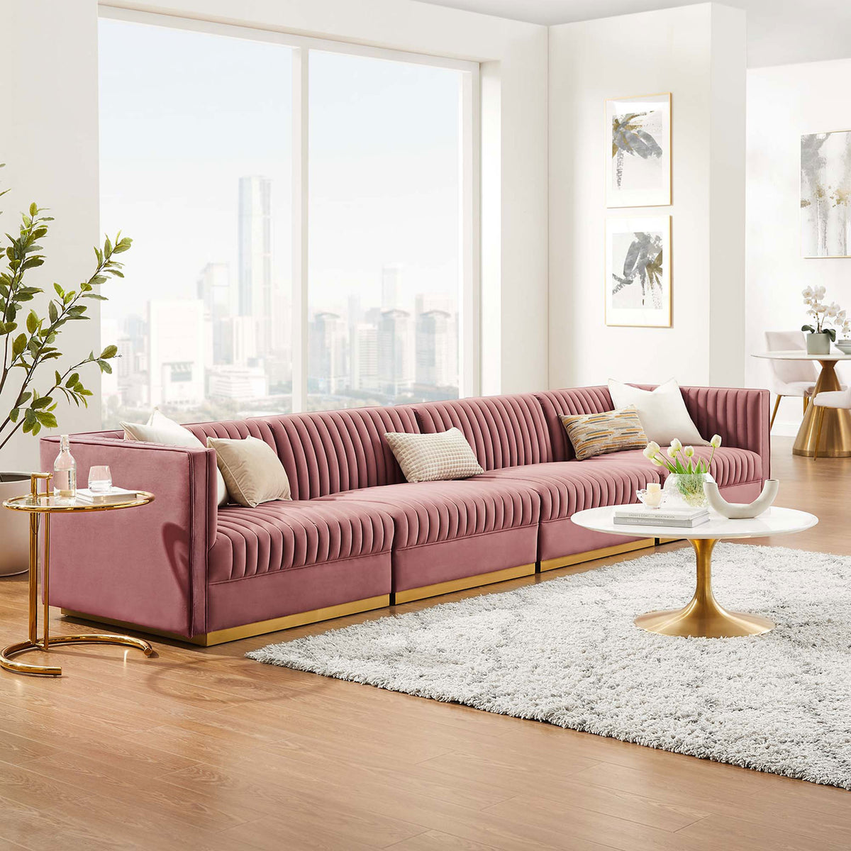 Long four seat dusty rose velvet sectional anchoring a contemporary living space with expansive city views. || EEI-5827-DUS || front_angle_room