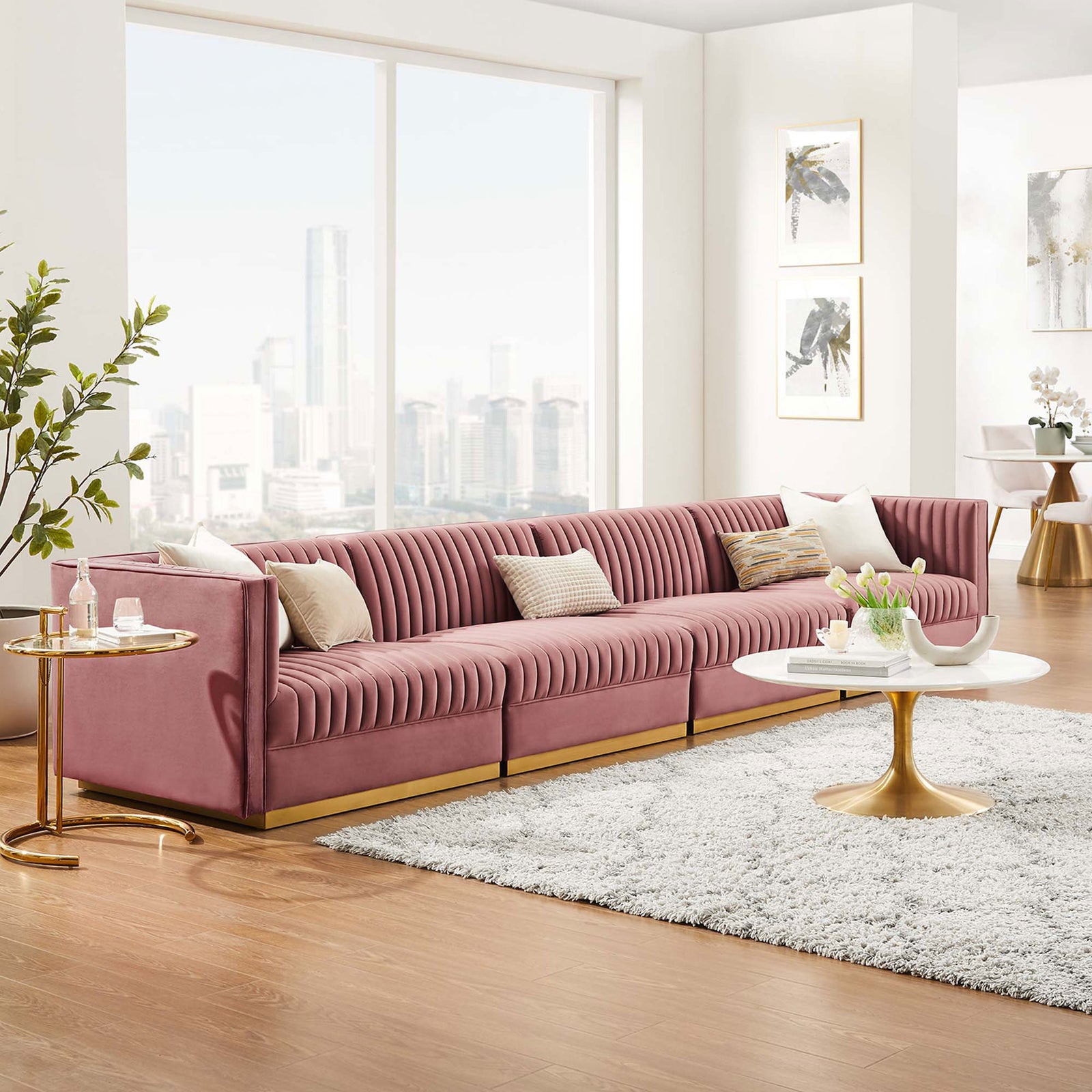 Long four seat dusty rose velvet sectional anchoring a contemporary living space with expansive city views. || EEI-5827-DUS || front_angle_room