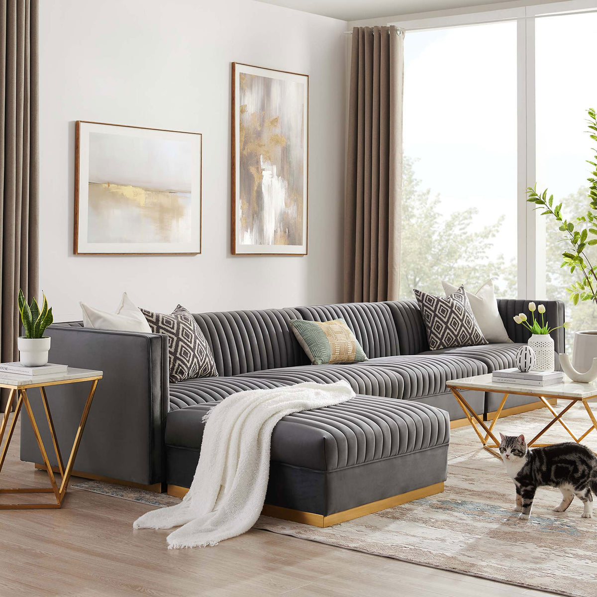 Gray velvet modular sectional with chaise in a modern living room layered with warm metallic accents. || EEI-5828-GRY || front_angle_room