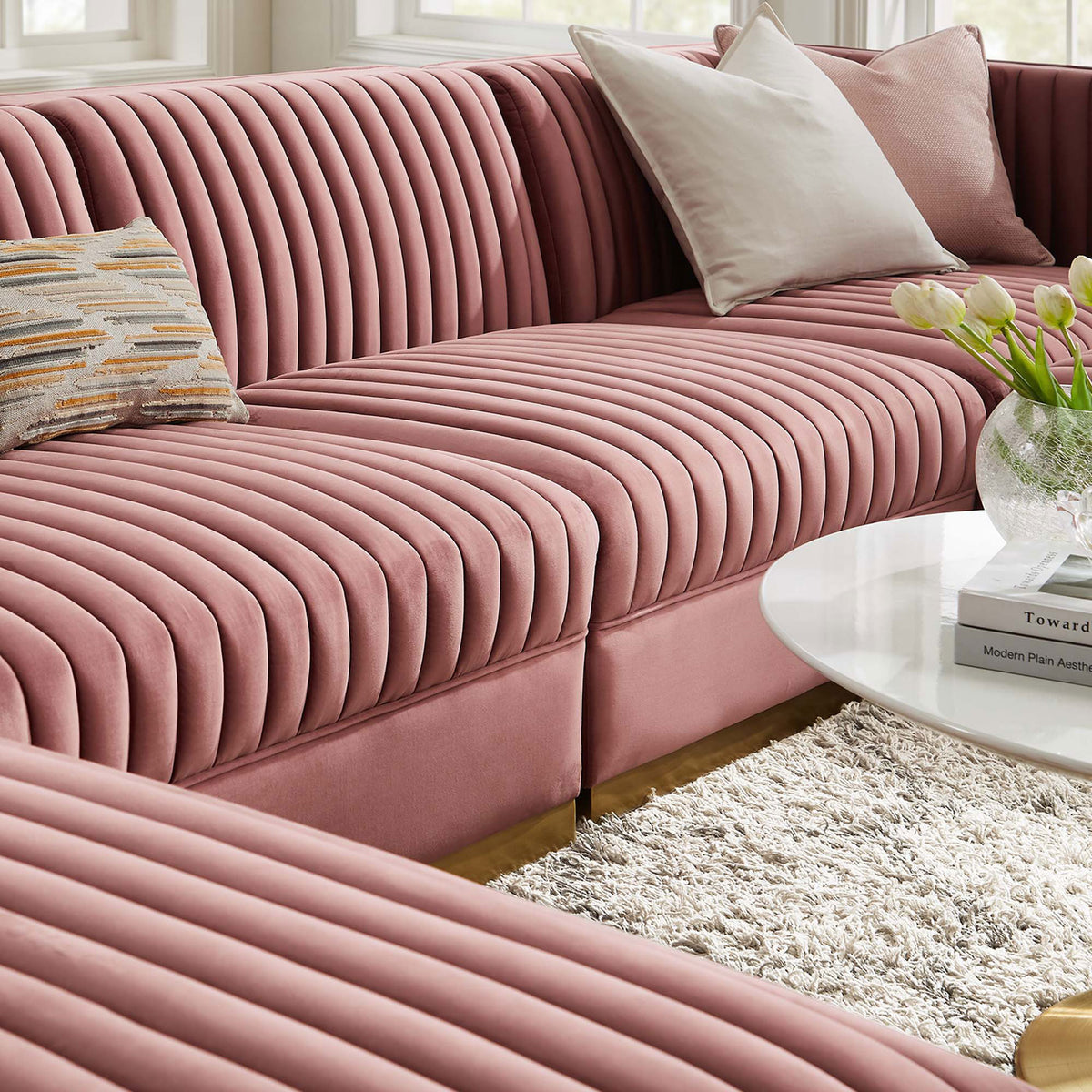 Soft performance velvet seating layered with pillows and decor for a cozy modern lounging space || EEI-5841-DUS || detail_room