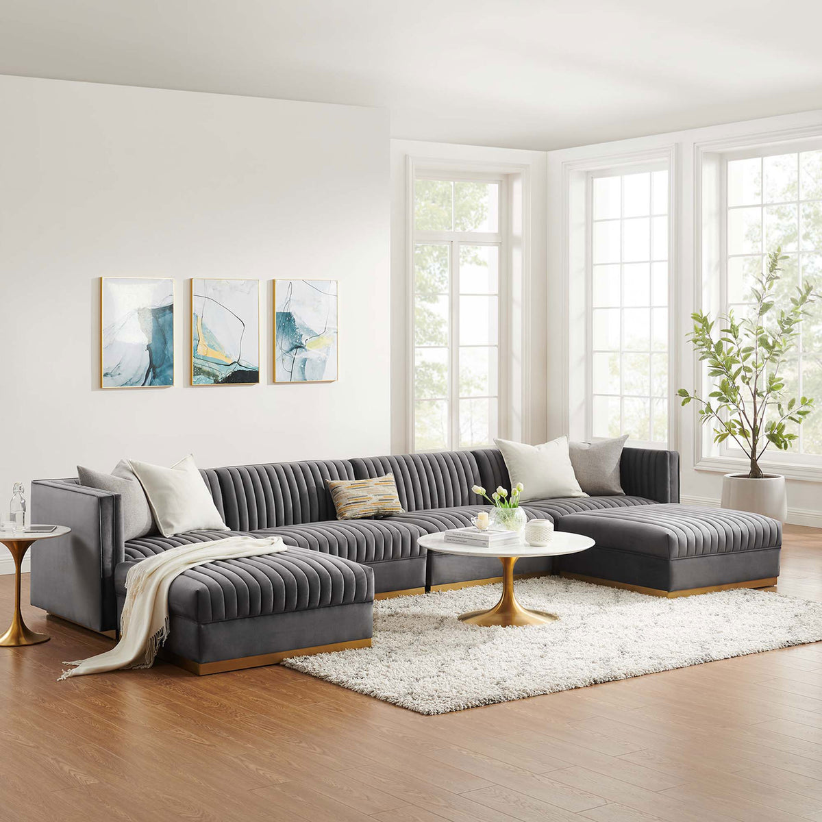 Gray velvet modular sectional styled in a bright living room with accent pillows, rug, and gold tables. || EEI-5841-GRY || front_angle_room