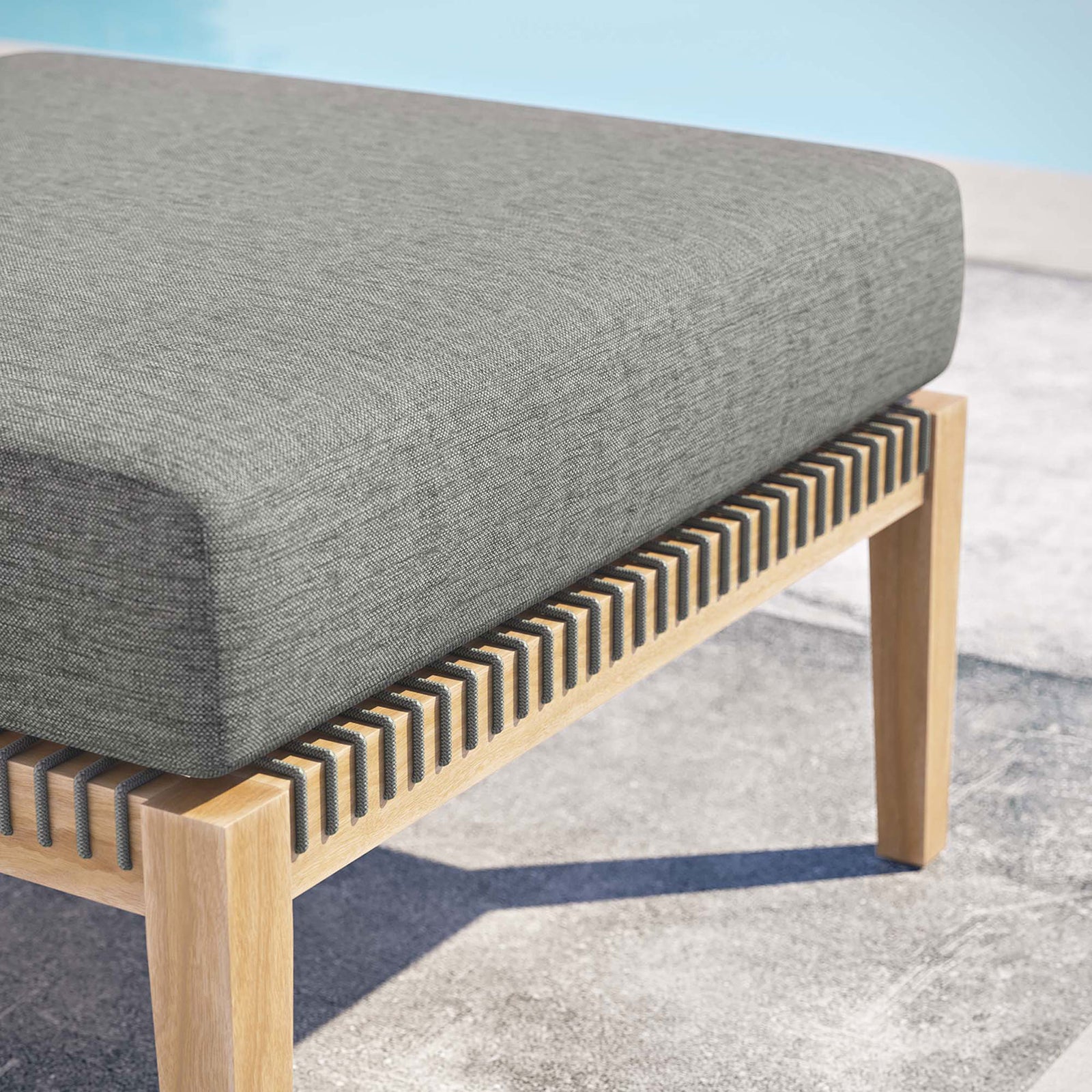 Graphite cushion teak ottoman styled by the pool, highlighting weather resistant materials || EEI-5854-GRY-GPH || detail_room