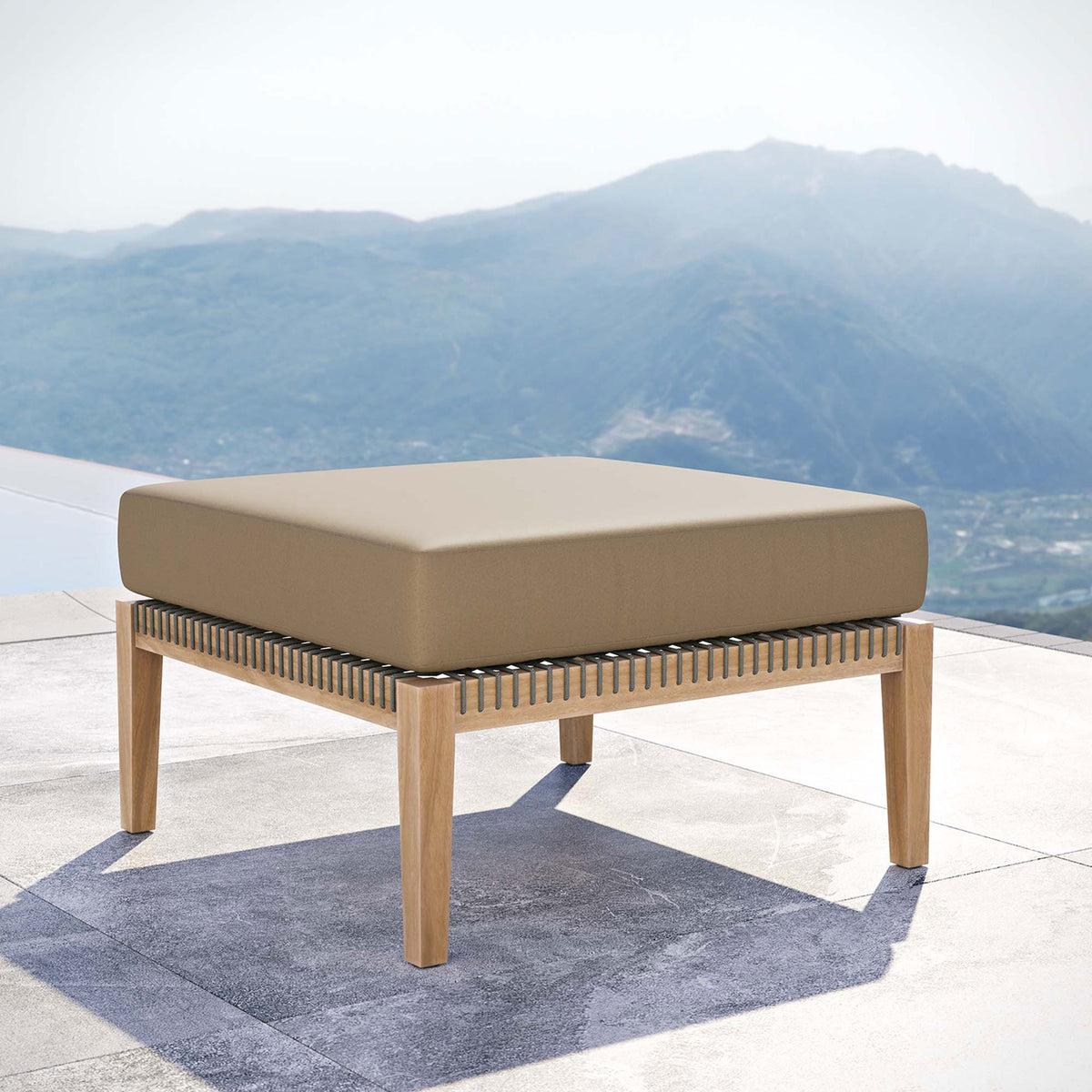 Light brown cushion teak patio ottoman placed by an infinity pool for resort style lounging || EEI-5854-GRY-LBR || front_angle_room