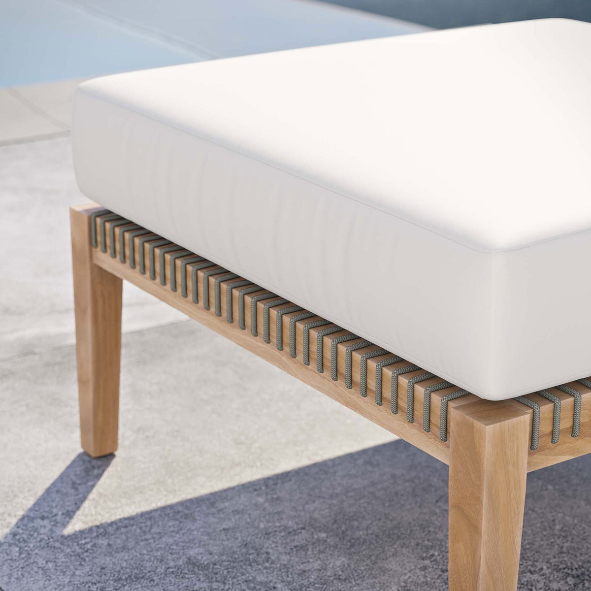 White cushion teak ottoman placed poolside, highlighting its breezy, resort inspired style || EEI-5854-GRY-WHI || detail_room