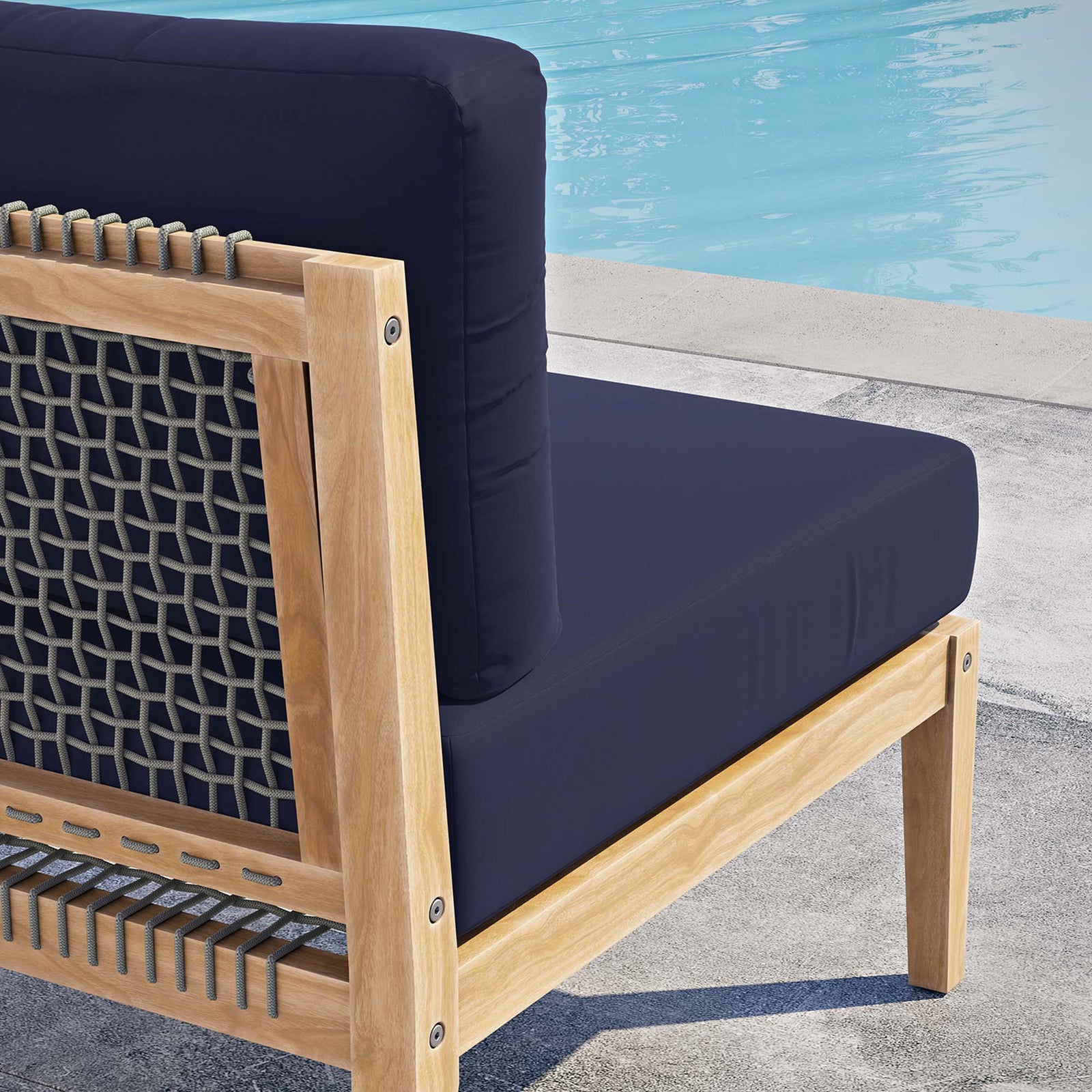 Navy cushion and woven rope back detail on teak frame enhancing the poolside seating area || EEI-5856-GRY-NAV || detail_room
