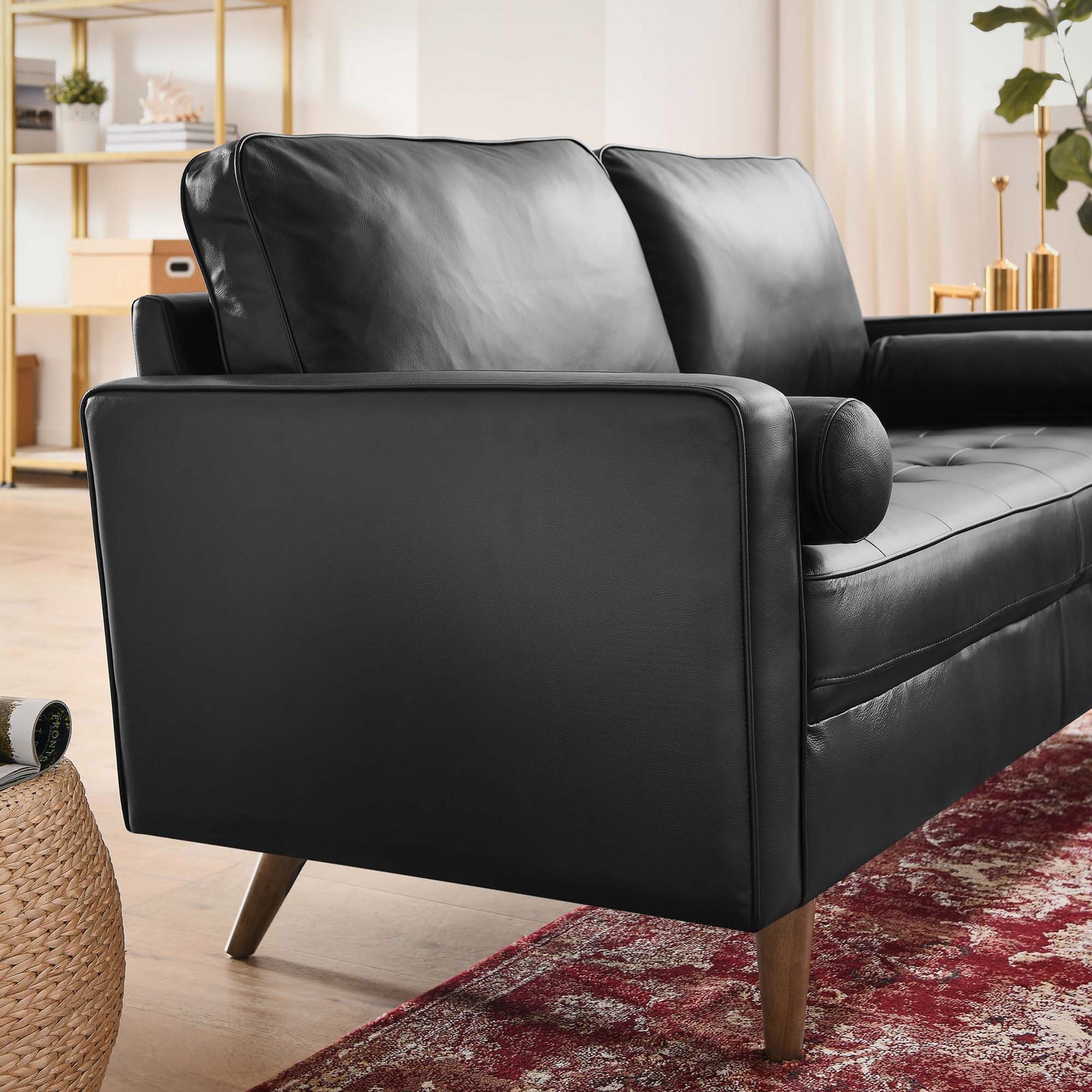 Black leather loveseat styled in a bright living room with bolster pillow and walnut legs || EEI-5870-BLK || detail_room
