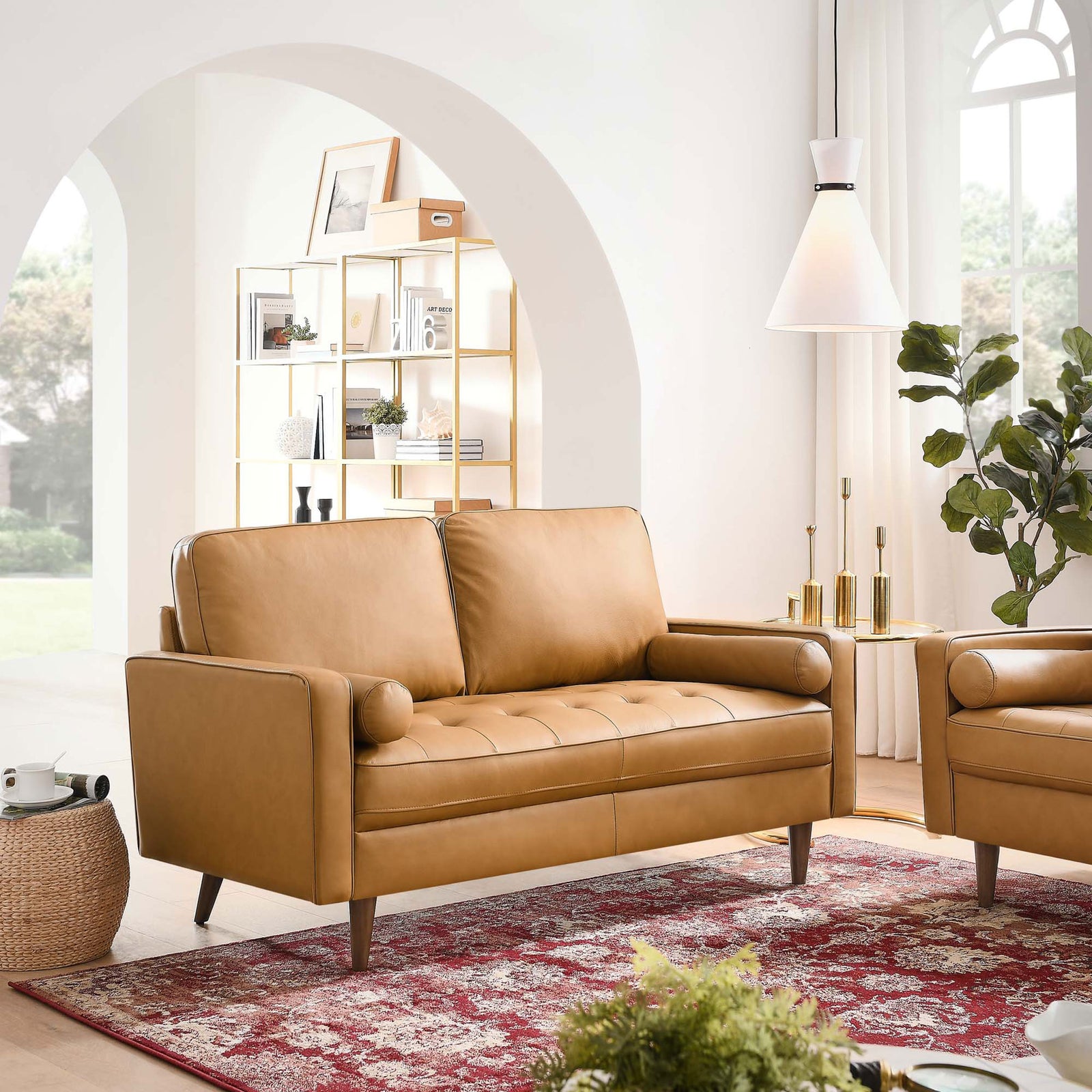 Tan leather loveseat in a bright living room with red patterned rug and modern decor || EEI-5870-TAN || front_room