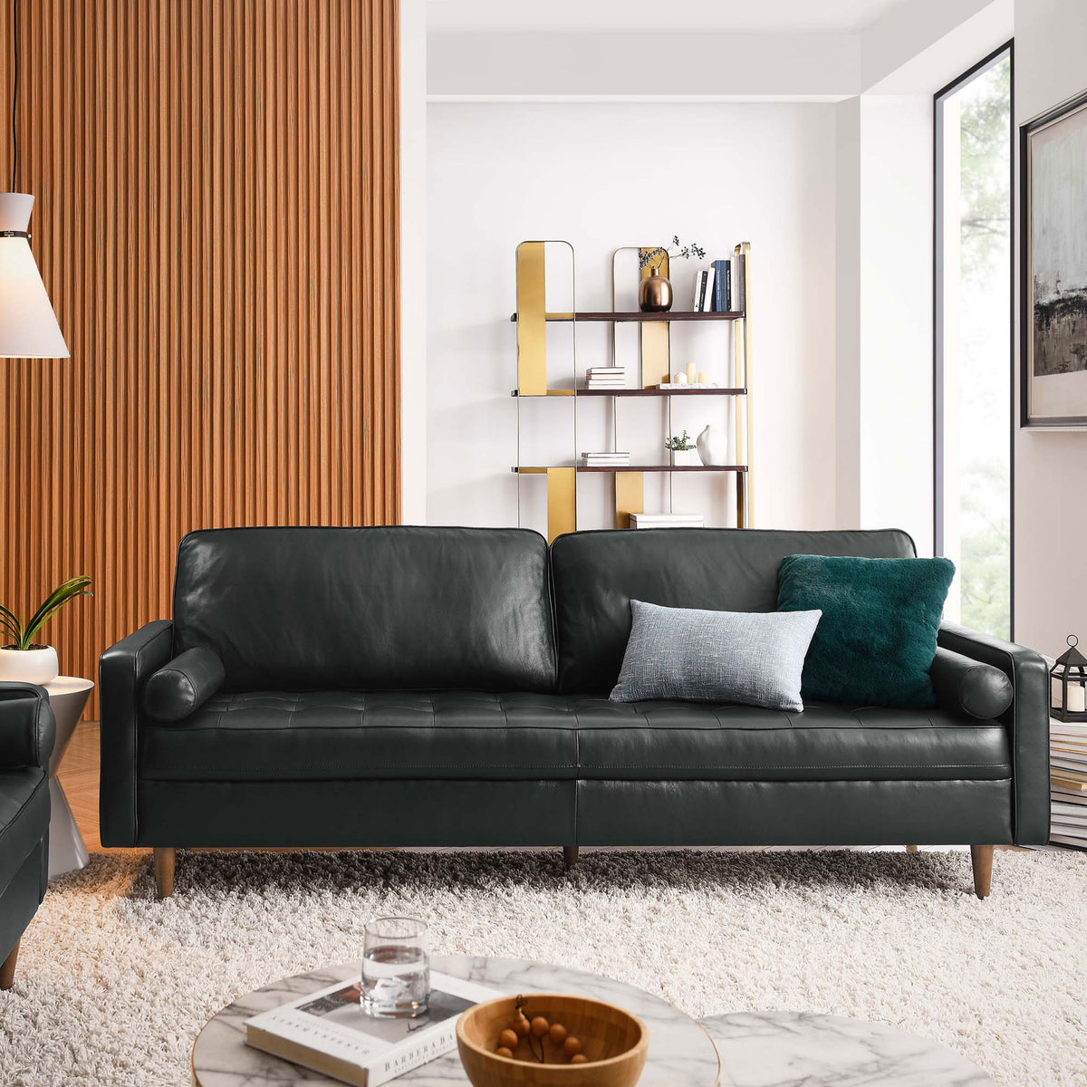 88 inch Valour black leather sofa styled in a bright living room with windows, plush rug, and contemporary accents. || EEI-5871-BLK || front_angle_room