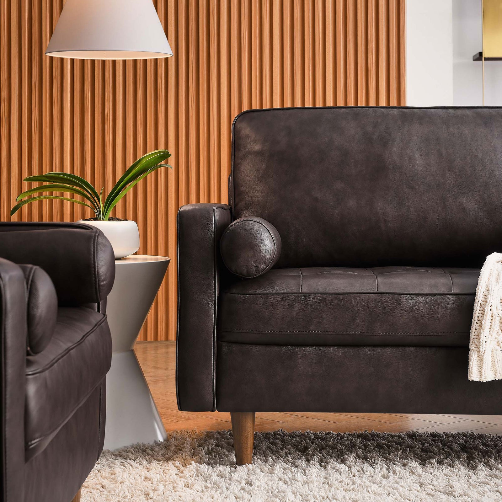 Rich brown leather arm and bolster pillow pair with soft textures for an inviting, layered living space || EEI-5871-BRN || detail_room