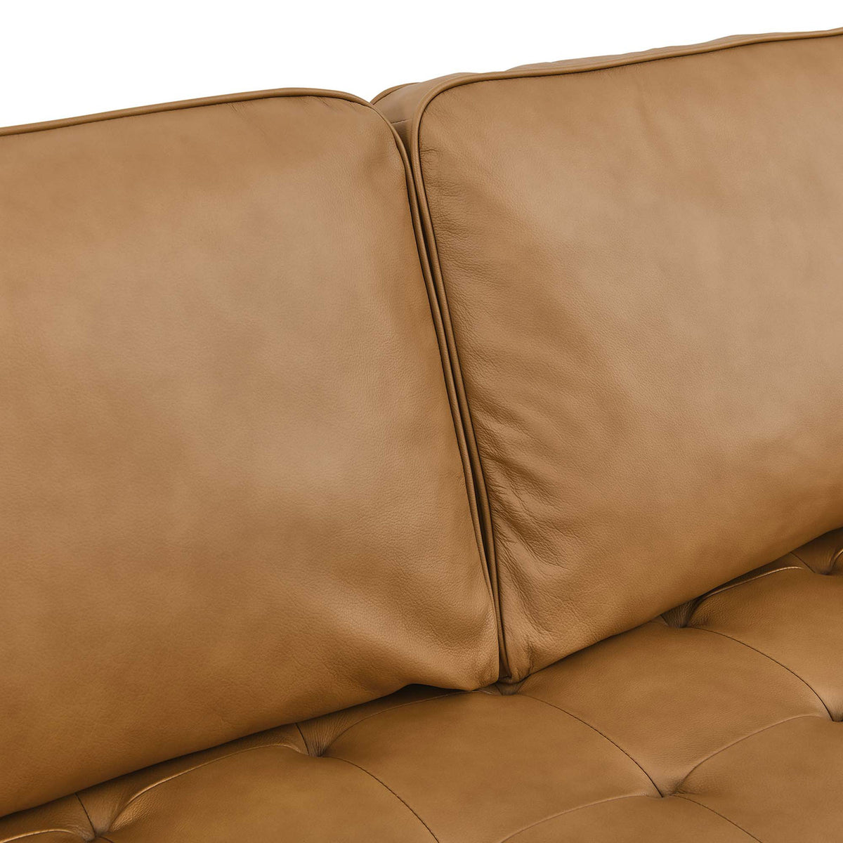 Soft tan leather cushions with subtle grain and biscuit tufting for a refined, comfortable seating surface. || EEI-5873-TAN || detail_studio