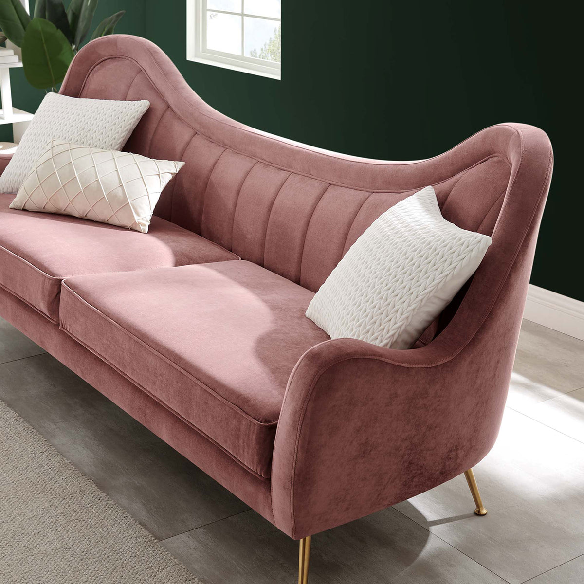 Dusty rose velvet sofa styled with patterned accent pillows in a contemporary green-walled living space. || EEI-5874-DUS || detail_room
